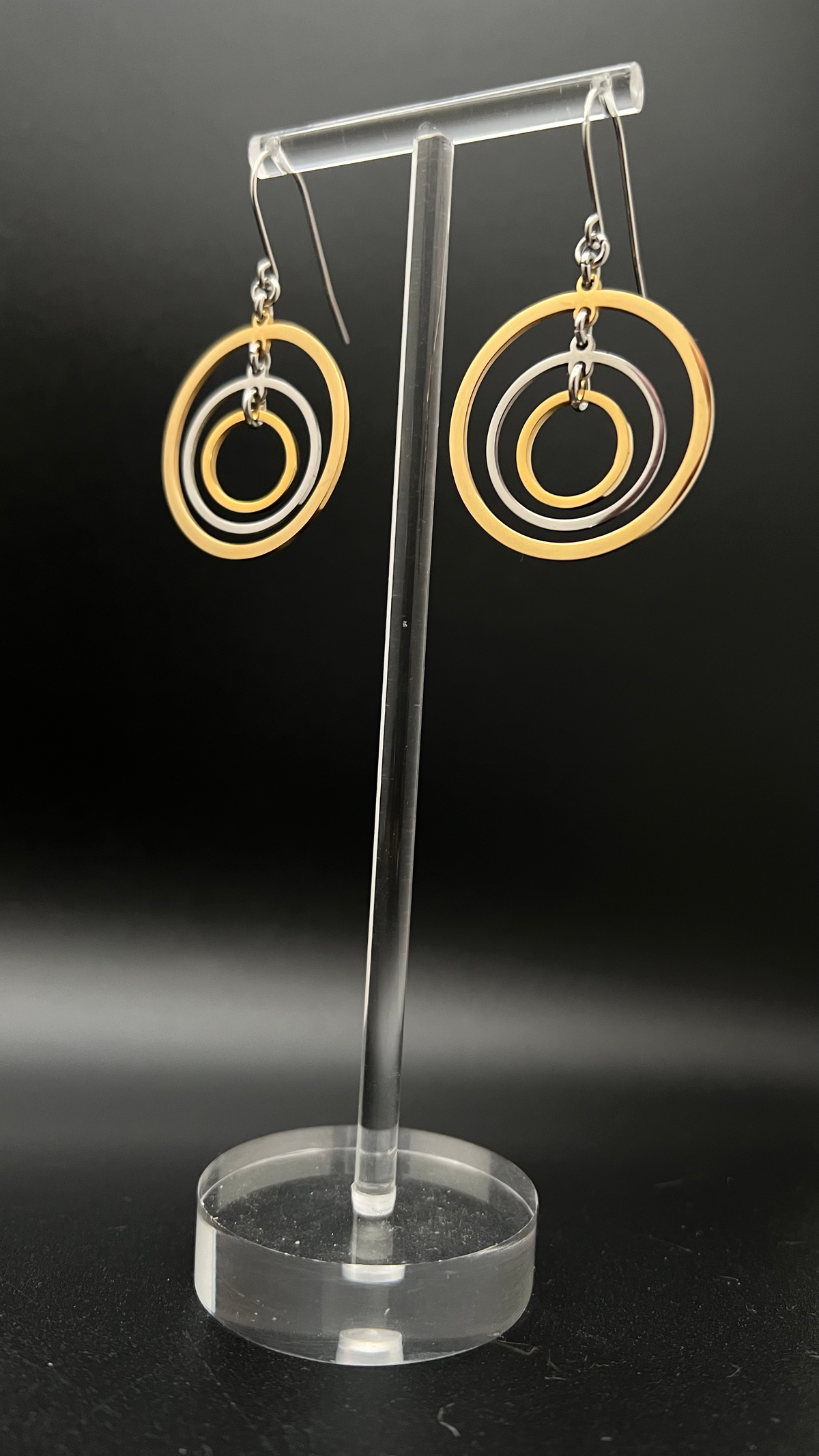Mixed-metal stainless steel earrings with three interlinked concentric gold and silver rings and stainless steel ear hooks, 5 cm length — Lawless Jewellery.