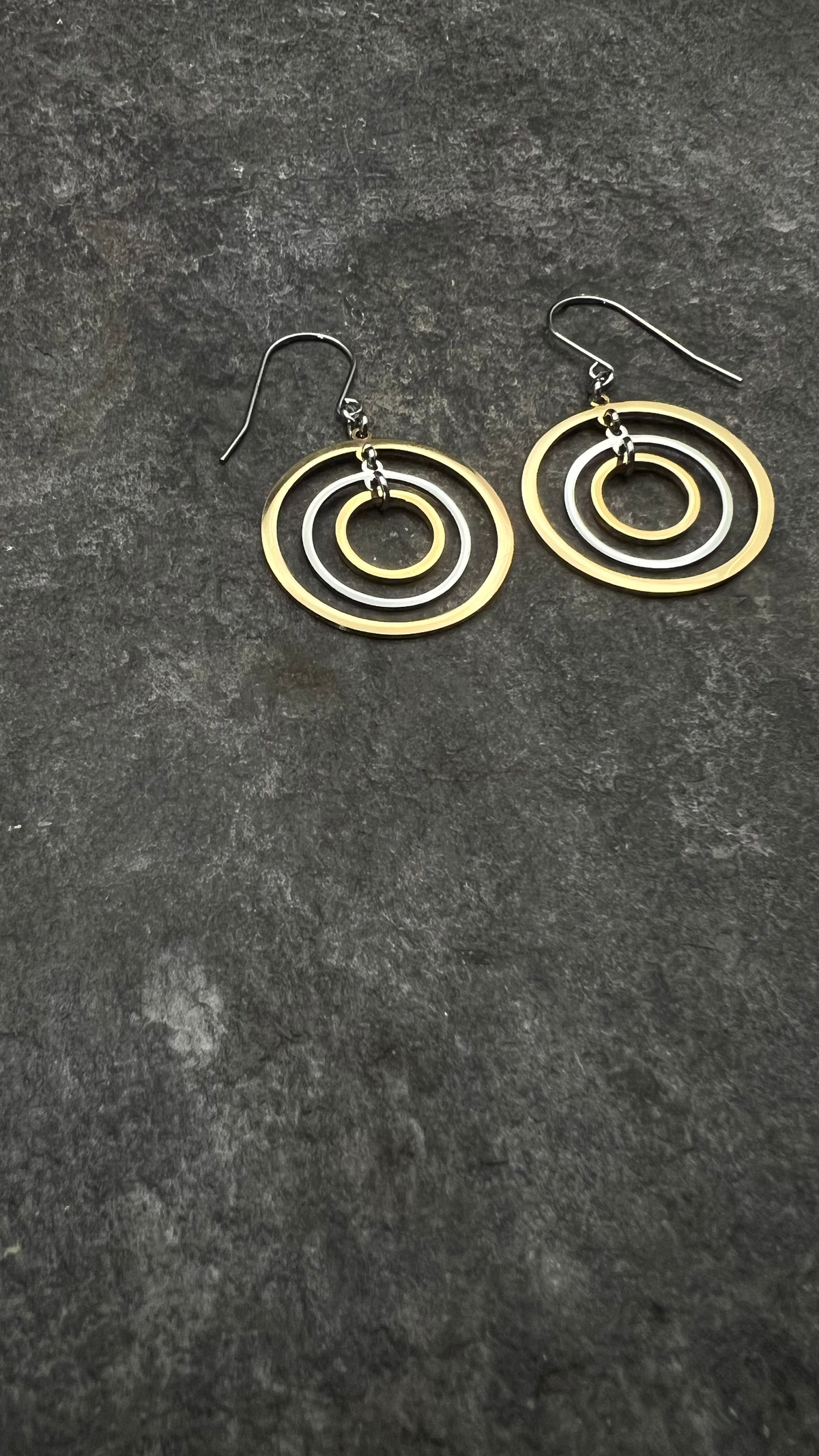 xMixed-metal stainless steel earrings with three interlinked concentric gold and silver rings and stainless steel ear hooks, 5 cm length — Lawless Jewellery.