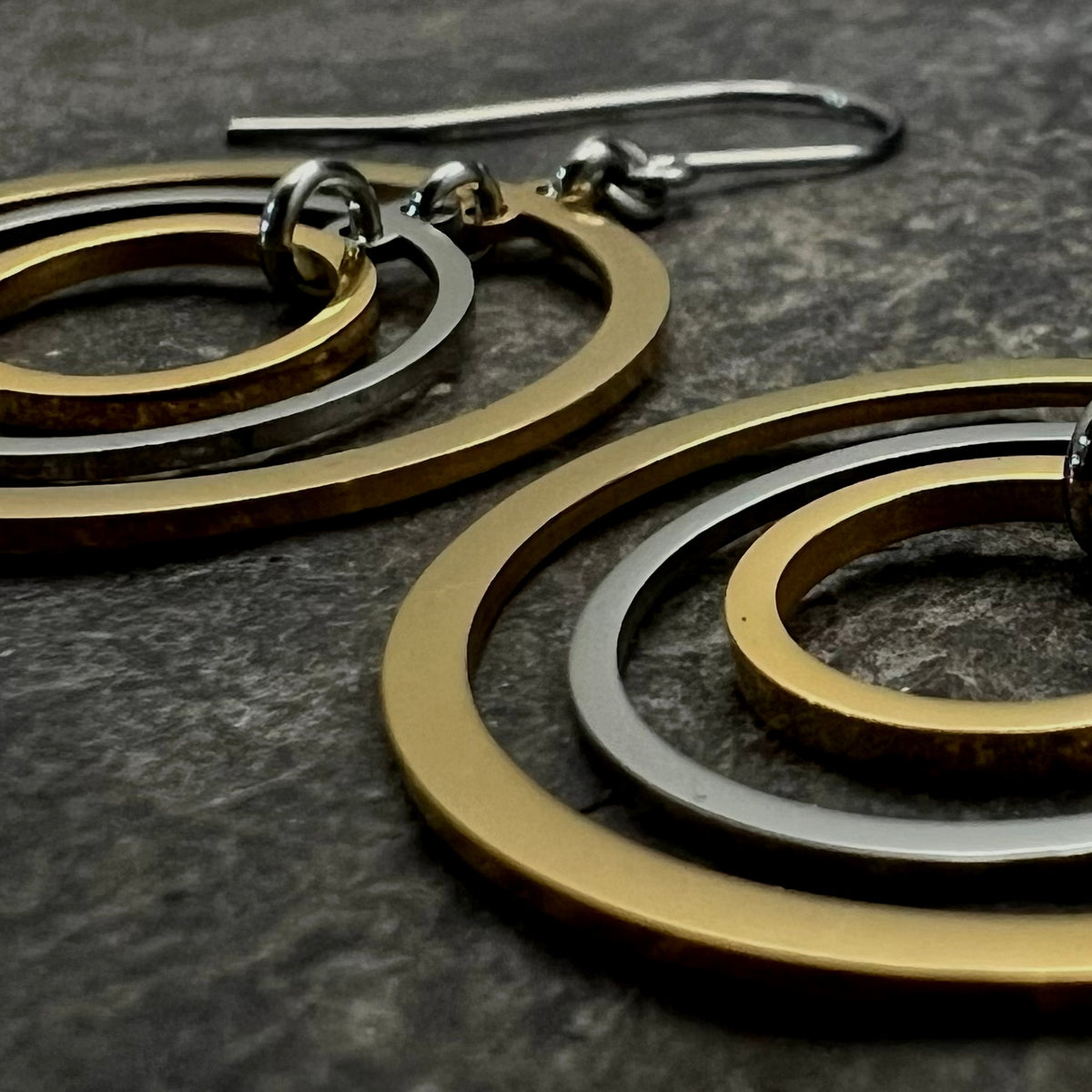 Mixed-metal stainless steel earrings with three interlinked concentric gold and silver rings and stainless steel ear hooks, 5 cm length — Lawless Jewellery.Cassini Align Earrings - Silver / Gold 30mm image 4