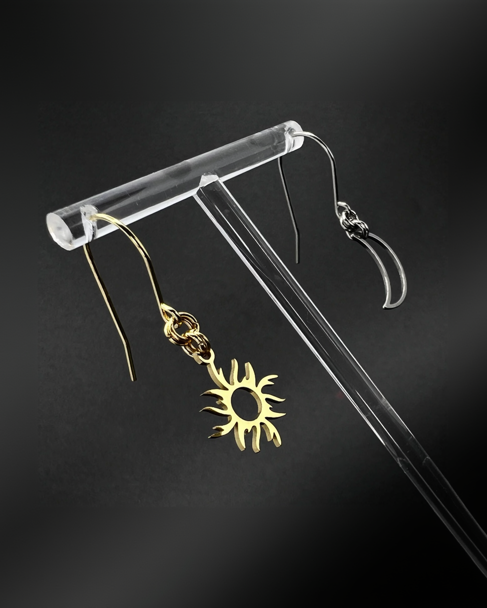 Mixed metal sun and moon earrings with silver crescent moon and gold sun charms on stainless steel hooks, Eos Dawn Earrings by Lawless Jewellery.