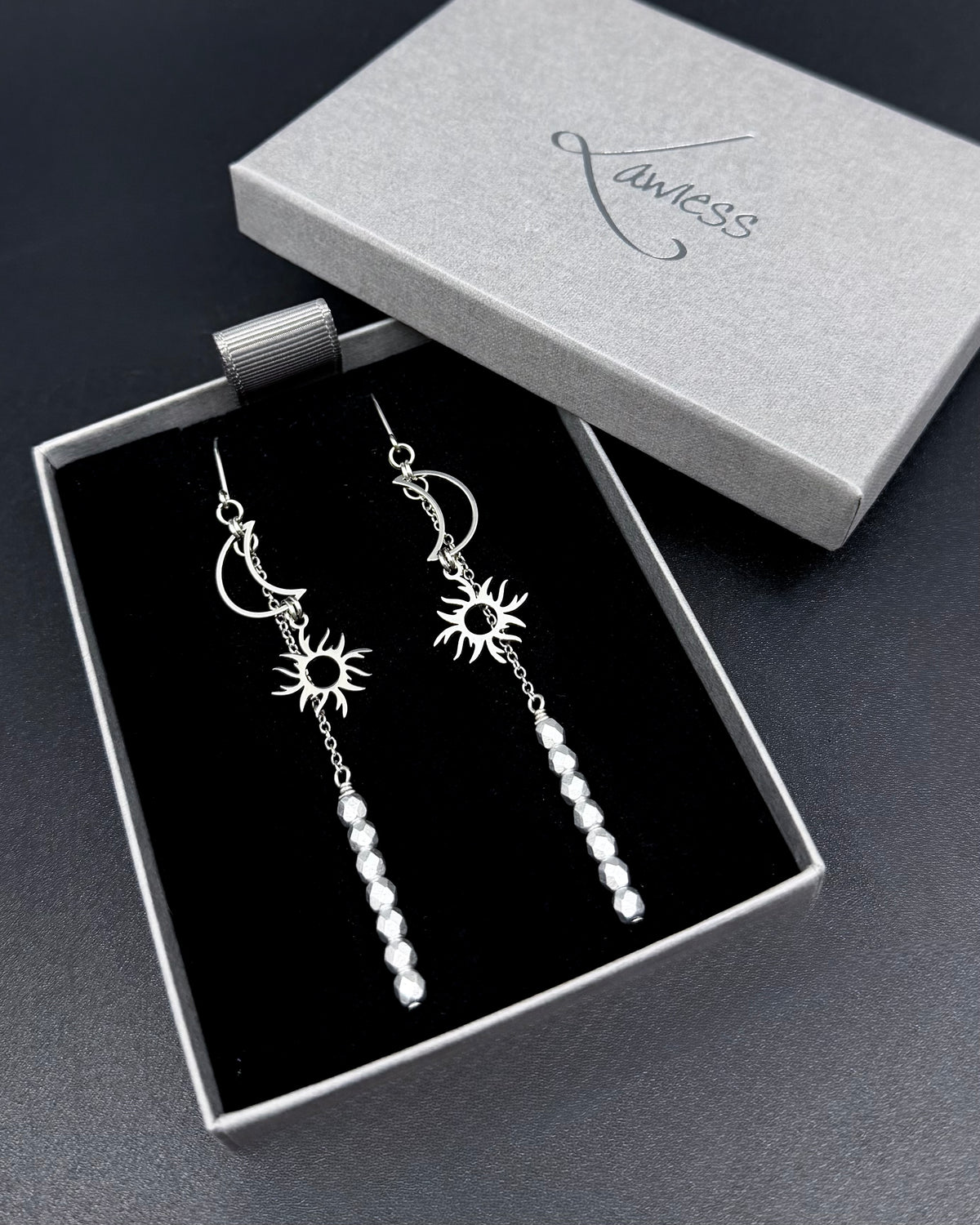 Long silver celestial earrings with sun and moon charms and fire-polished crystal drops from the Lawless Eos Threshold collection.