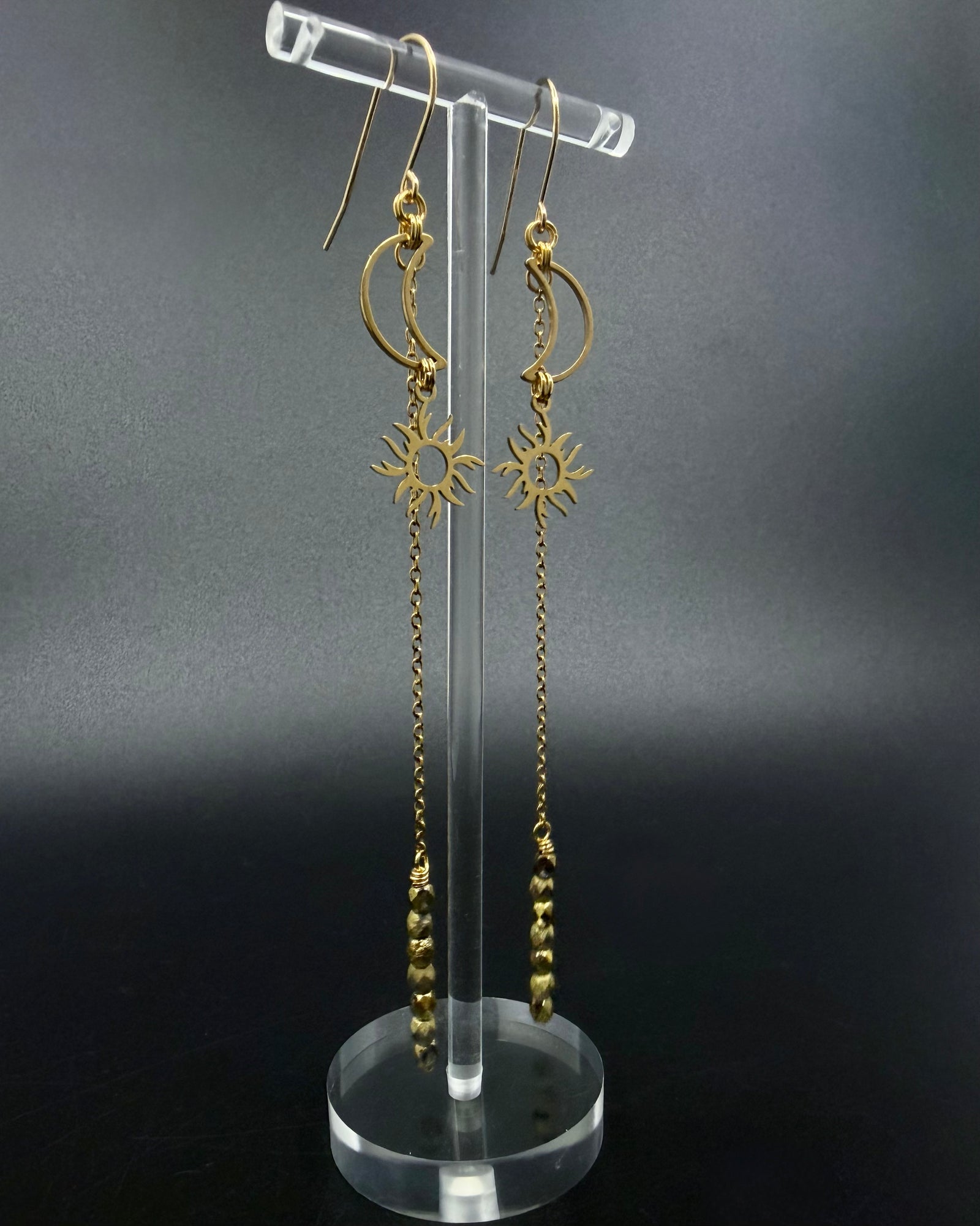 Long gold celestial earrings featuring crescent moon and sun charms with extended chain and fire-polished crystal, Eos Threshold Earrings by Lawless Jewellery.