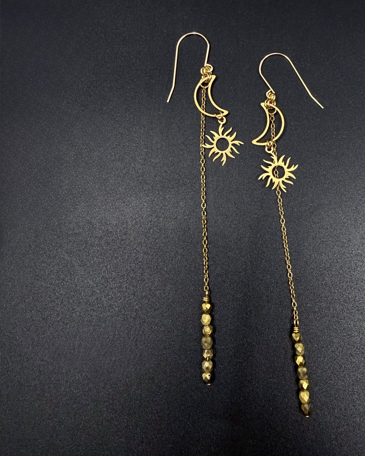 Long gold celestial earrings featuring crescent moon and sun charms with extended chain and fire-polished crystal, Eos Threshold Earrings by Lawless Jewellery.