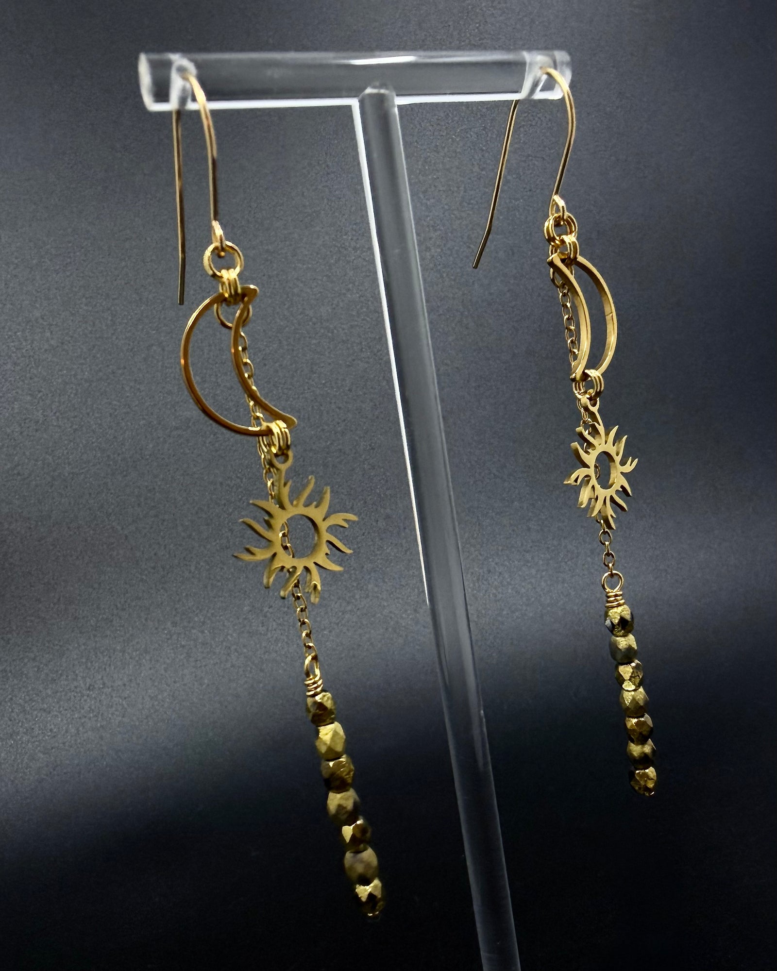 Long gold celestial earrings featuring sun and moon charms with fire-polished crystal drops from the Lawless Eos Threshold collection