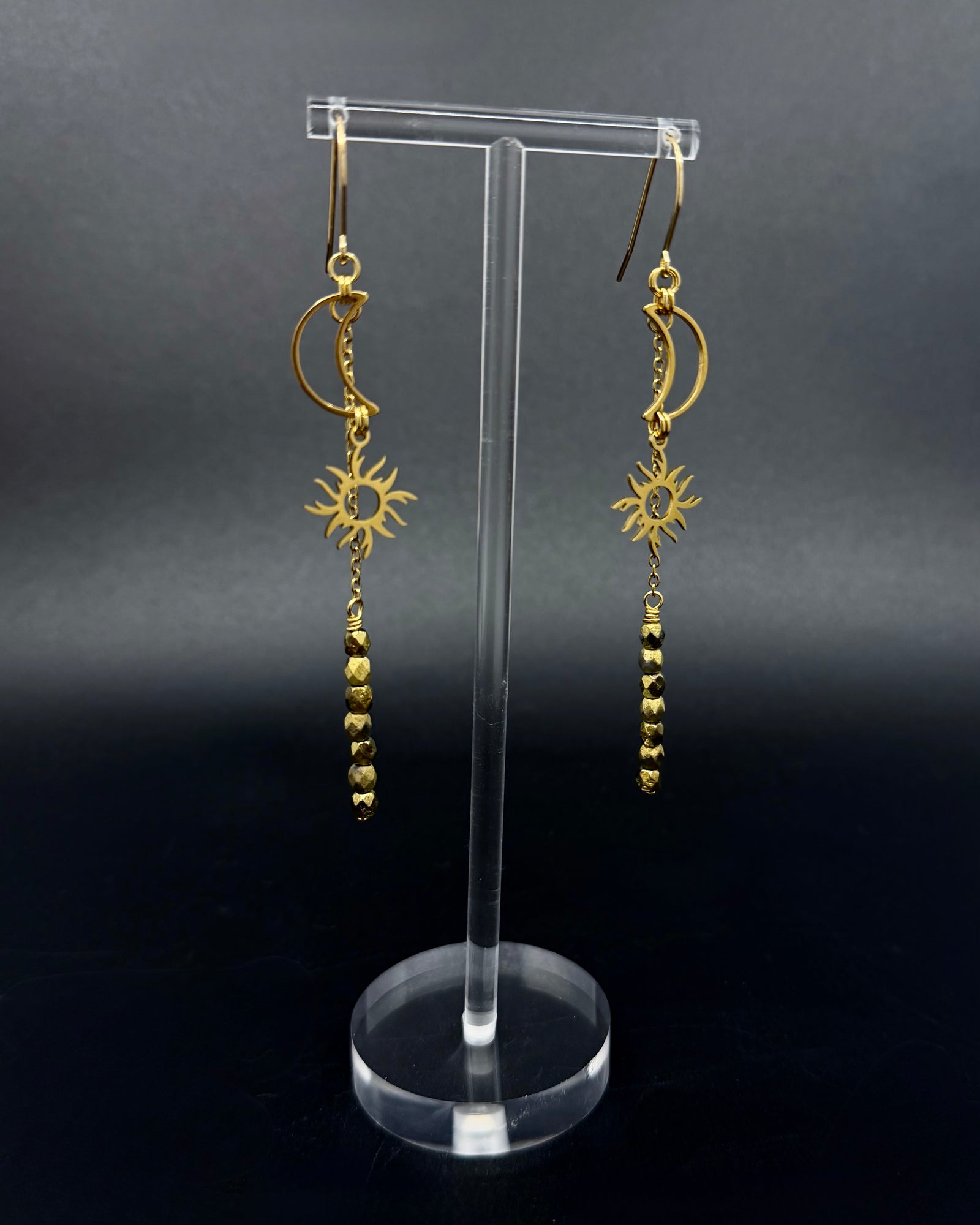 Long gold celestial earrings featuring sun and moon charms with fire-polished crystal drops from the Lawless Eos Threshold collection