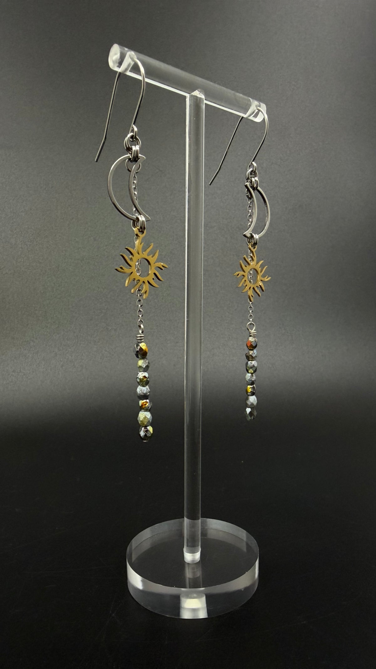 Long mixed-metal celestial earrings with silver moon and gold sun charms and fire-polished crystal drops from the Lawless Eos Threshold collection.