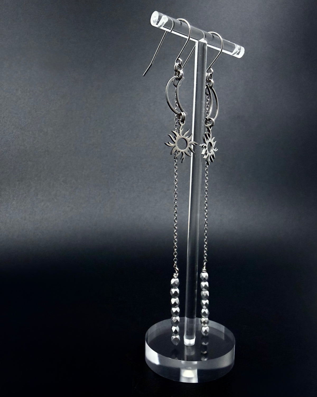 Long silver celestial earrings with crescent moon and sun charms, extended chain and fire-polished crystal, Eos Threshold Earrings by Lawless Jewellery.