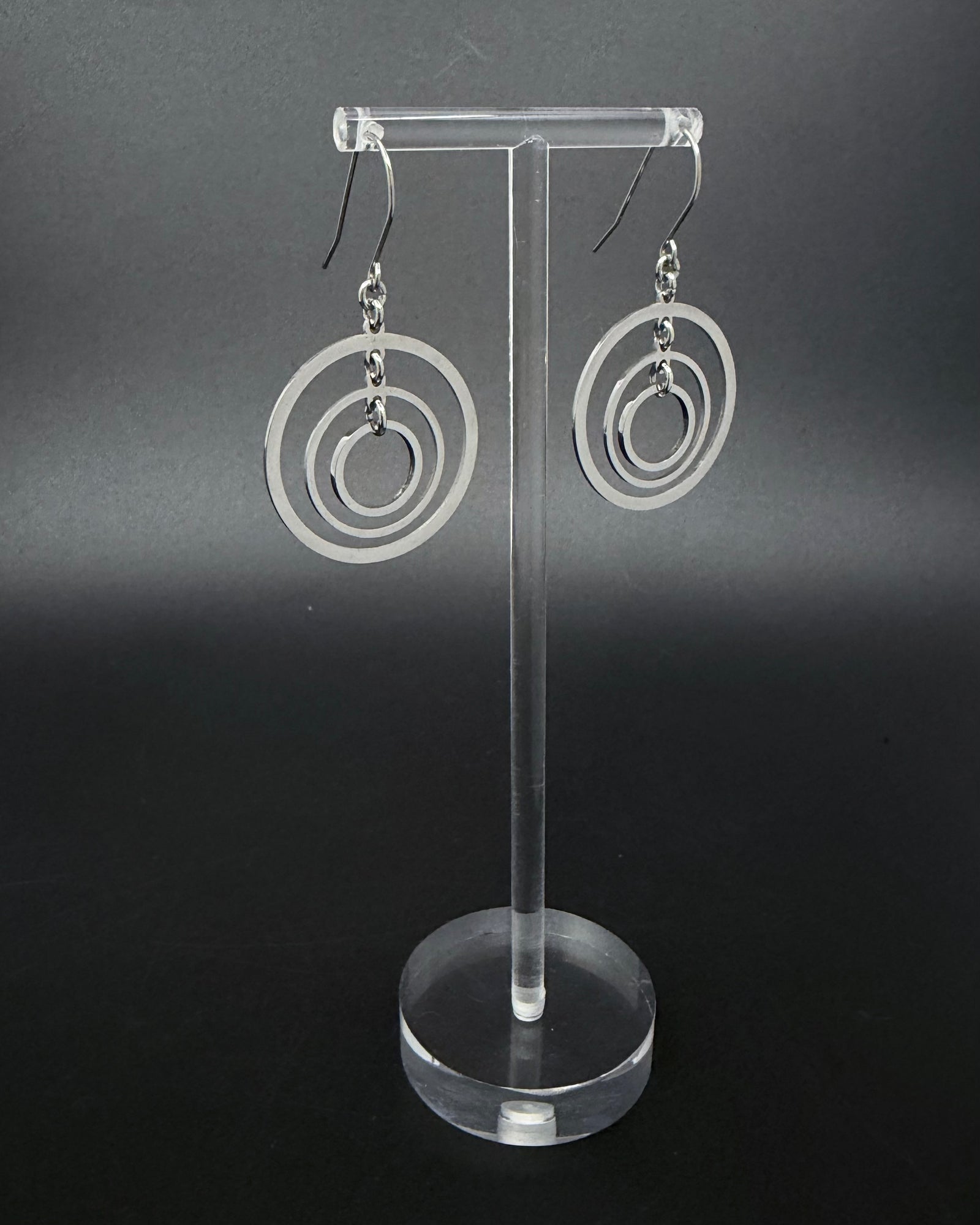 ilver stainless steel triple-ring earrings with three interlinked high-polish rings and stainless steel hooks, 5 cm length — Lawless Jewellery.
