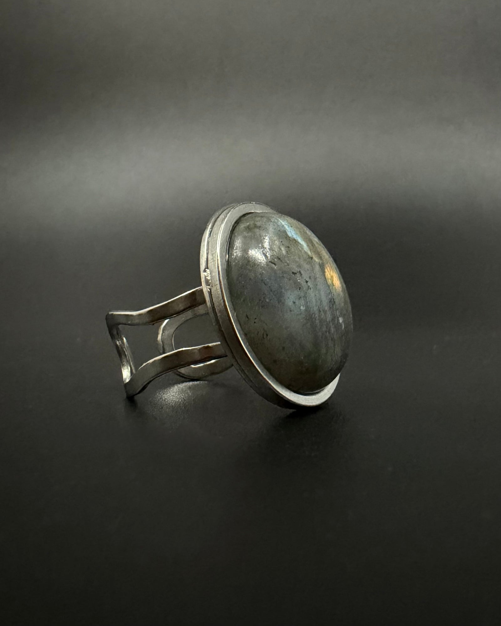 Silver adjustable double-shank ring with large 20 mm domed labradorite gemstone showing blue and grey flashes, Nebulae Core Ring by Lawless Jewellery.