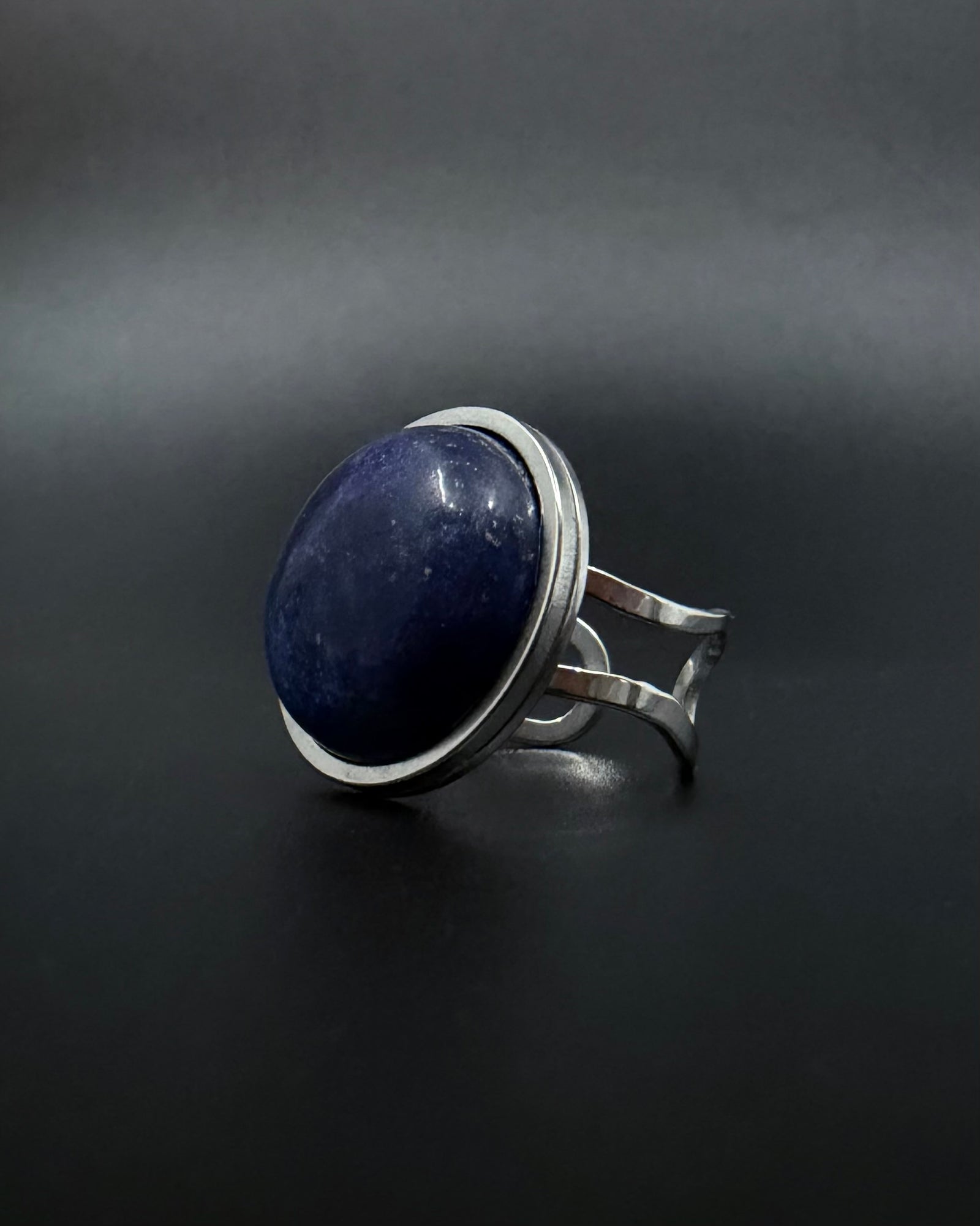Silver adjustable double-shank ring with large 20 mm domed lapis lazuli gemstone in deep blue tones, Nebulae Core Ring by Lawless Jewellery.