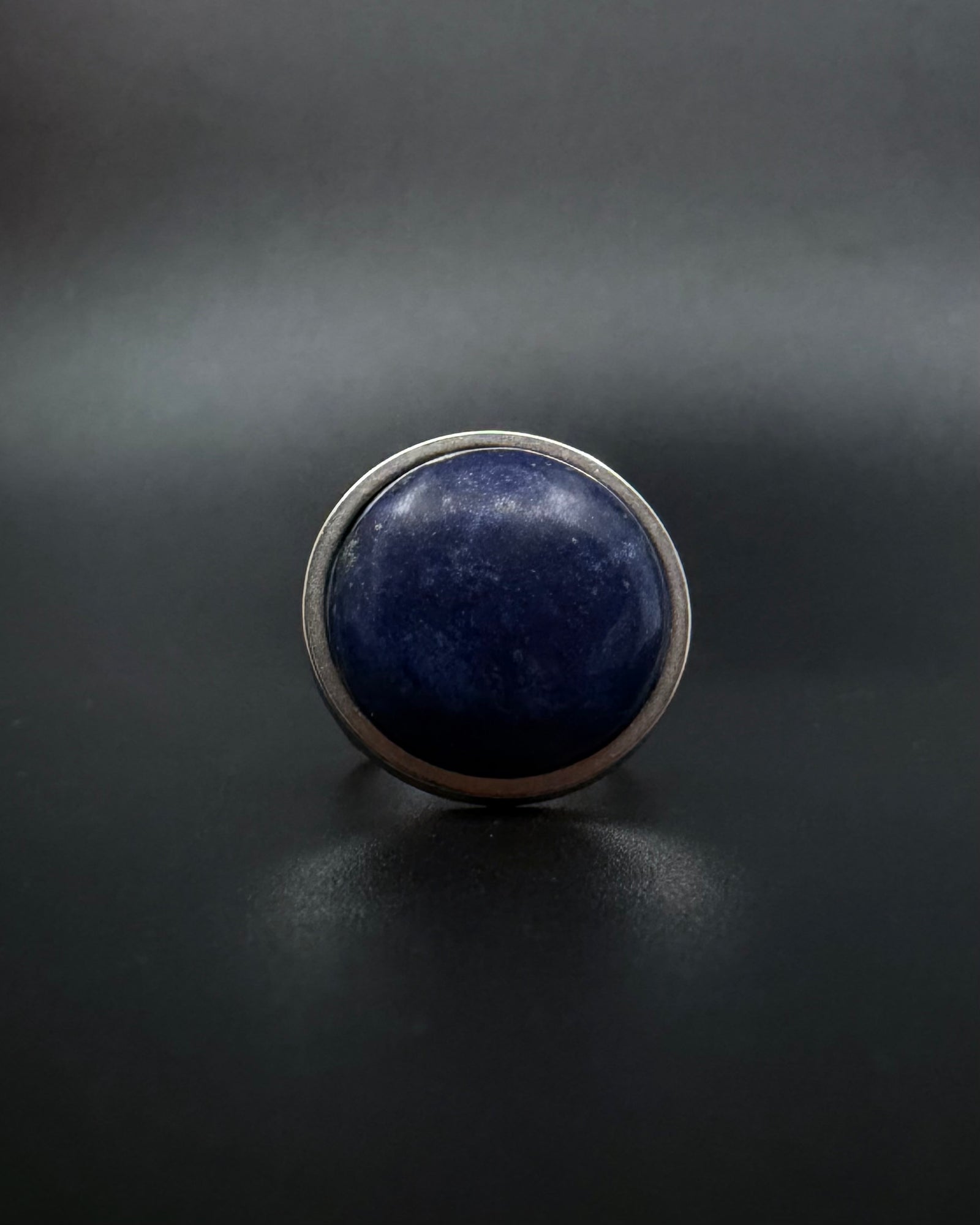 Silver adjustable double-shank ring with large 20 mm domed lapis lazuli gemstone in deep blue tones, Nebulae Core Ring by Lawless Jewellery.
