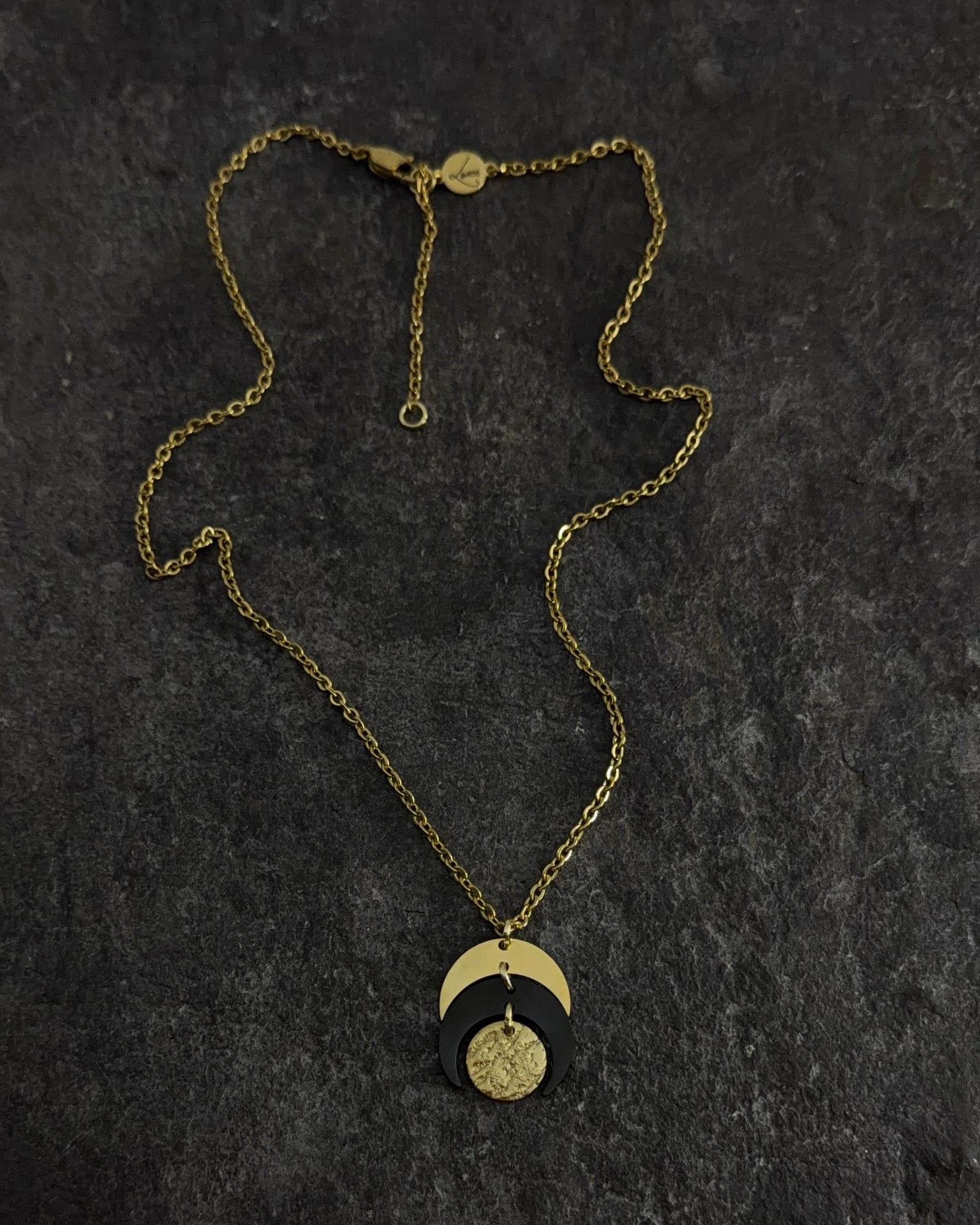 Gold and black stainless steel Luna Phase 20mm Necklace with sculptural crescent pendant and adjustable chain — Lawless Jewellery.