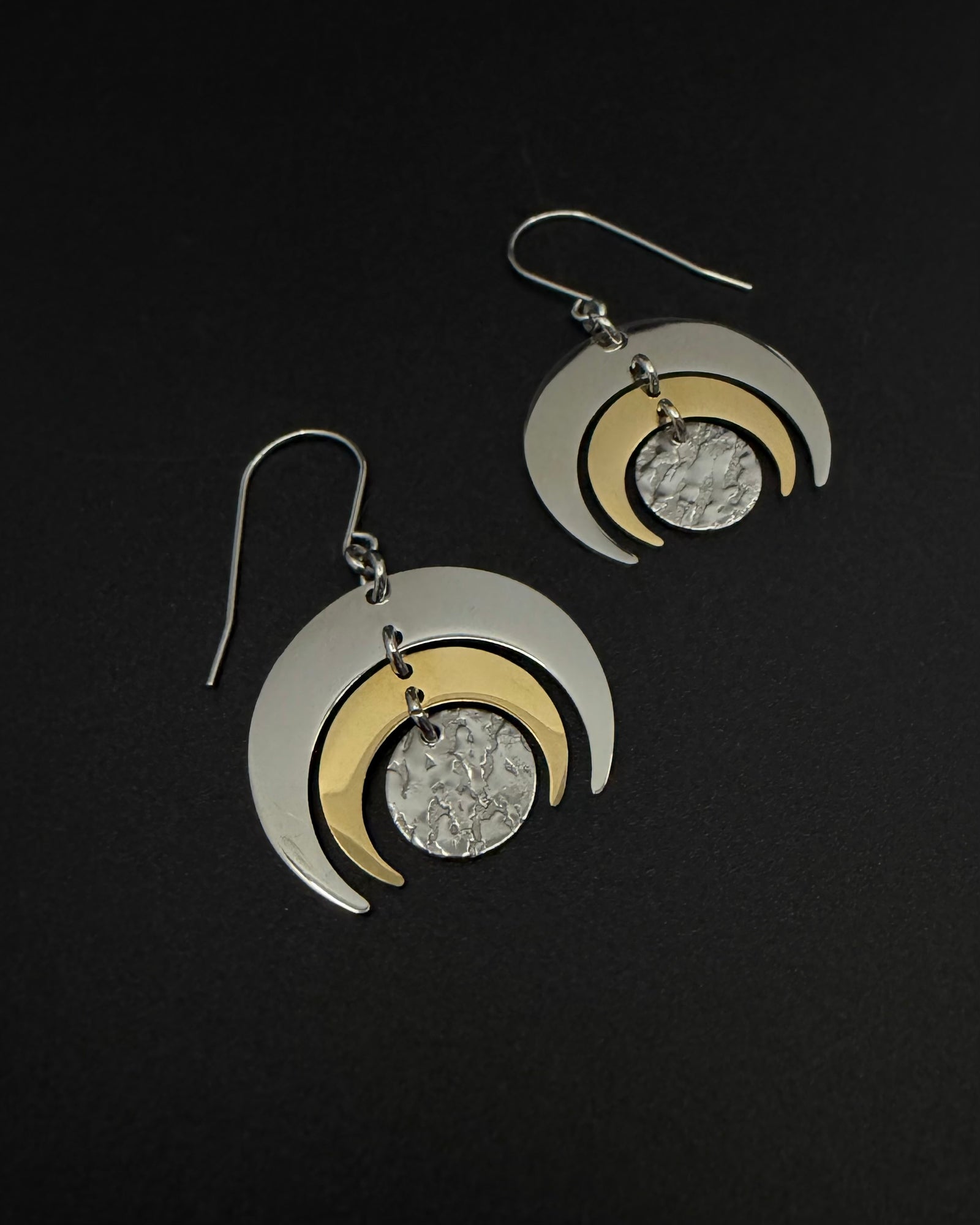 Mixed-metal Luna Phase Earrings with polished silver and gold crescents and a textured central disc, 30 mm wide and approx. 4.5 cm long — Lawless Jewellery