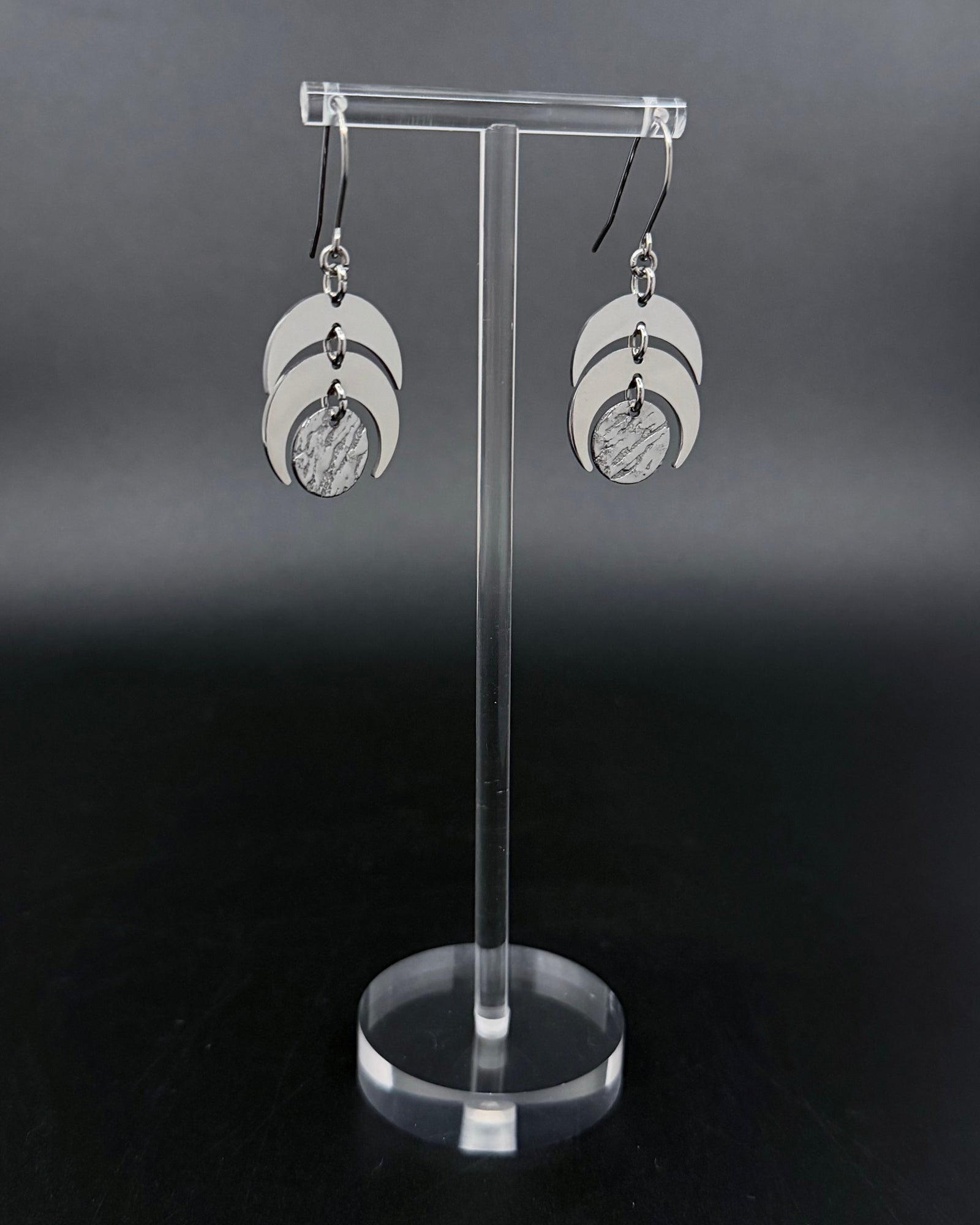 Silver Luna Phase Earrings with polished stainless-steel crescents and textured central disc, 20 mm wide and 4 cm long — Lawless Jewellery