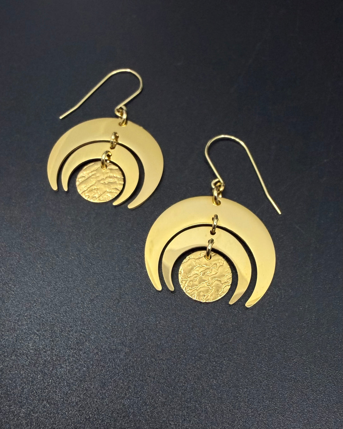 All gold Luna Phase Earrings in gold-plated stainless steel with triple crescent design and textured central disc, 30mm width.