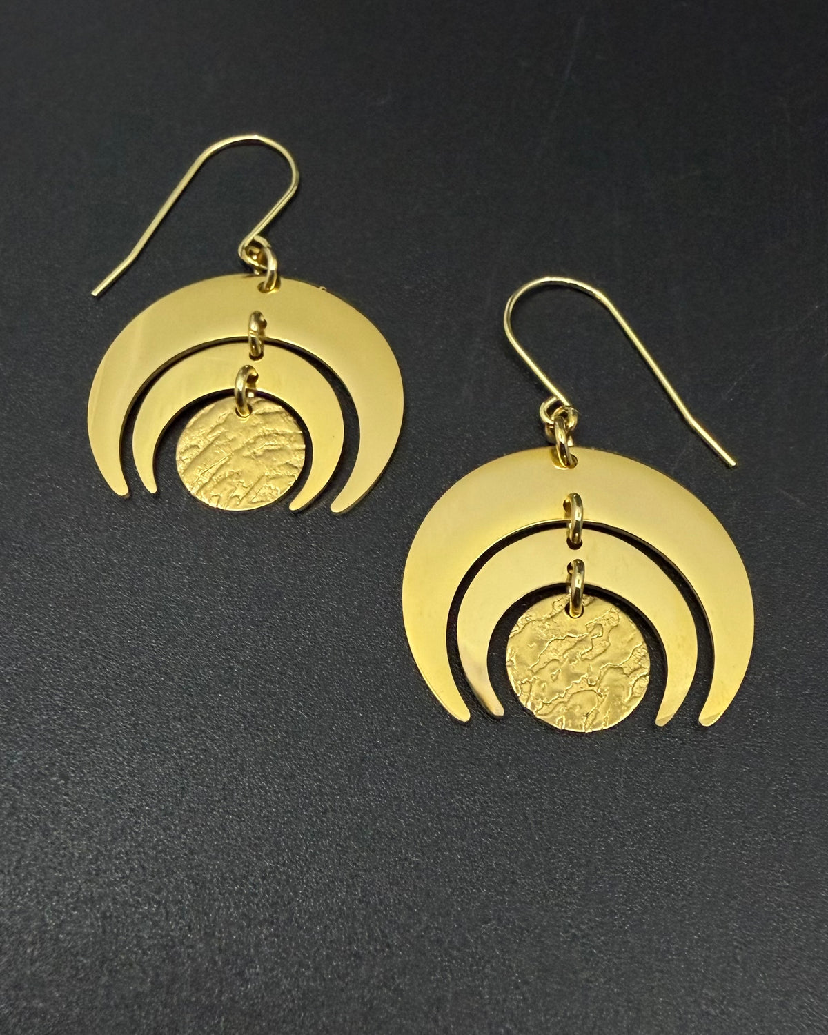 All gold Luna Phase Earrings in gold-plated stainless steel with triple crescent design and textured central disc, 30mm width.
