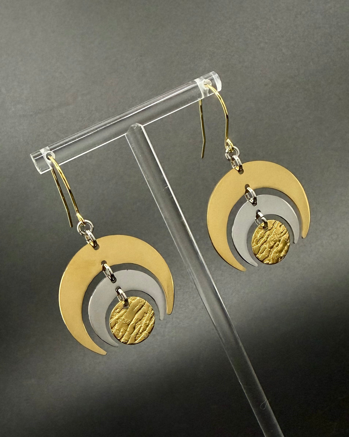 Gold and silver stainless steel Luna Phase Earrings with triple crescent design and textured central disc, 30mm width