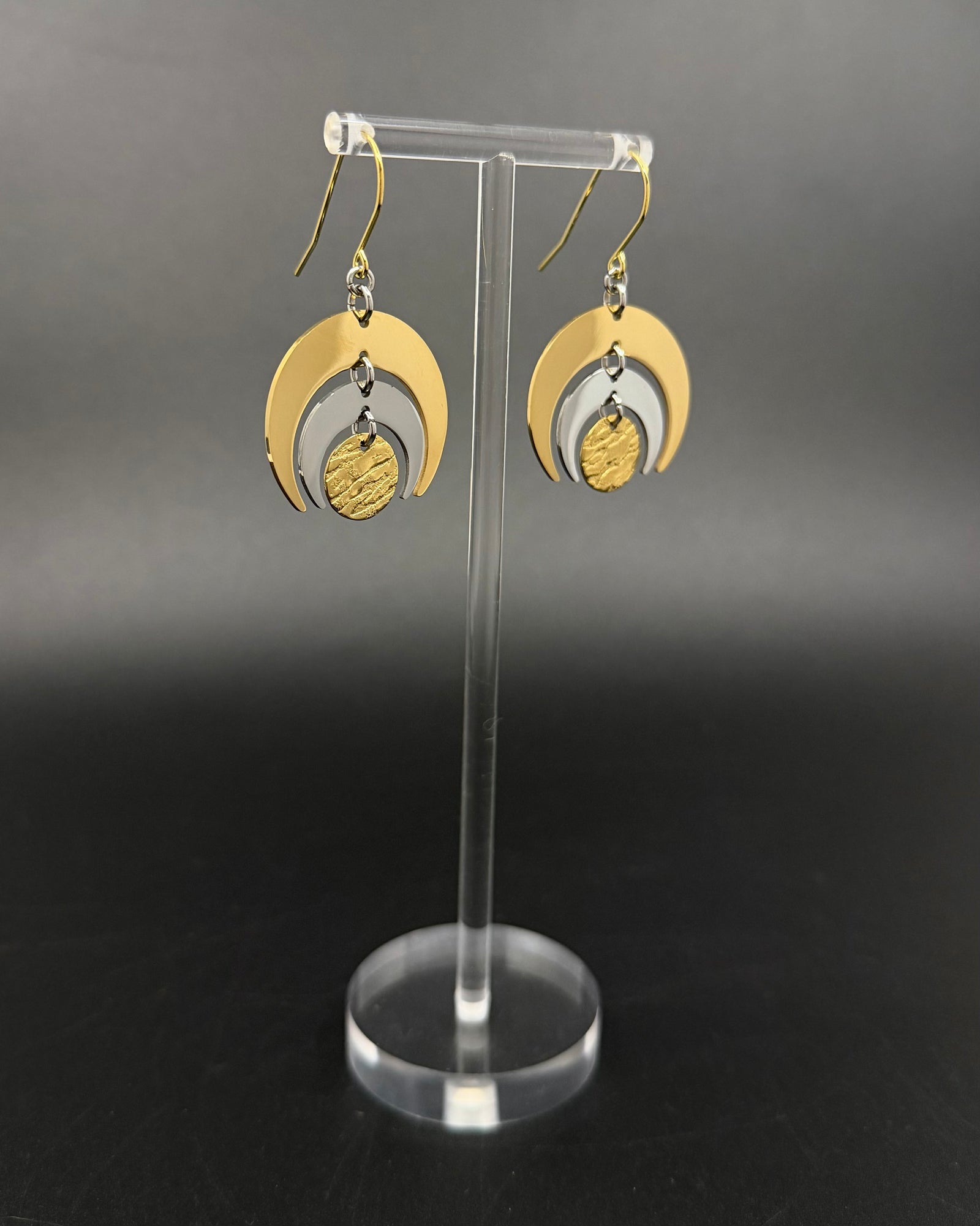 Gold and silver stainless steel Luna Phase Earrings with triple crescent design and textured central disc, 30mm width
