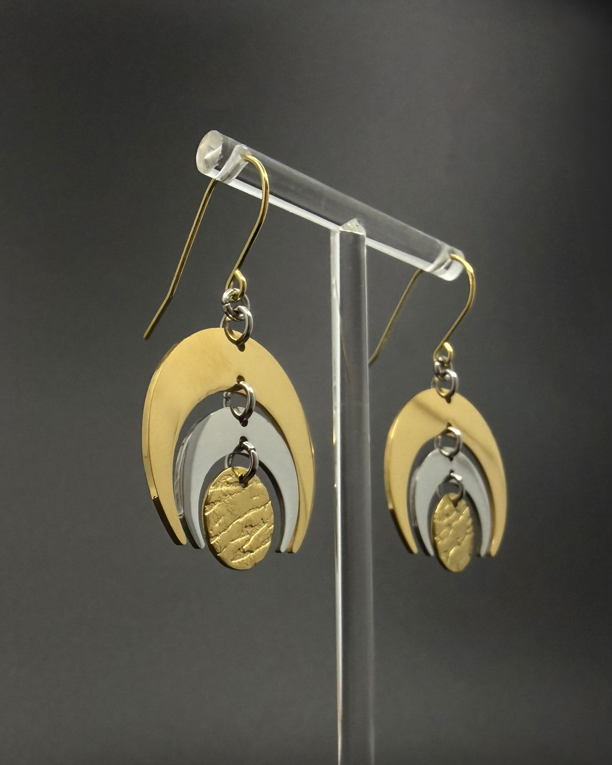 Gold and silver stainless steel Luna Phase Earrings with triple crescent design and textured central disc, 30mm width