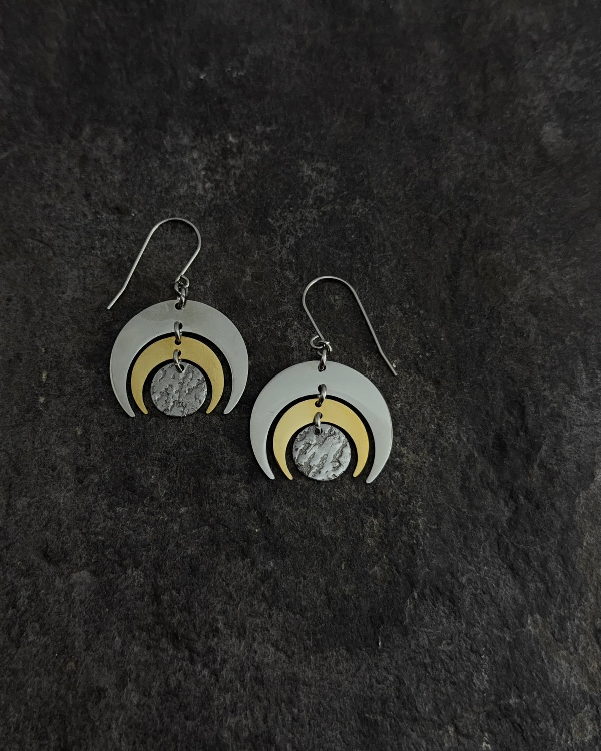 Mixed-metal Luna Phase Earrings with polished silver and gold crescents and a textured central disc, 30 mm wide and approx. 4.5 cm long — Lawless Jewellery
