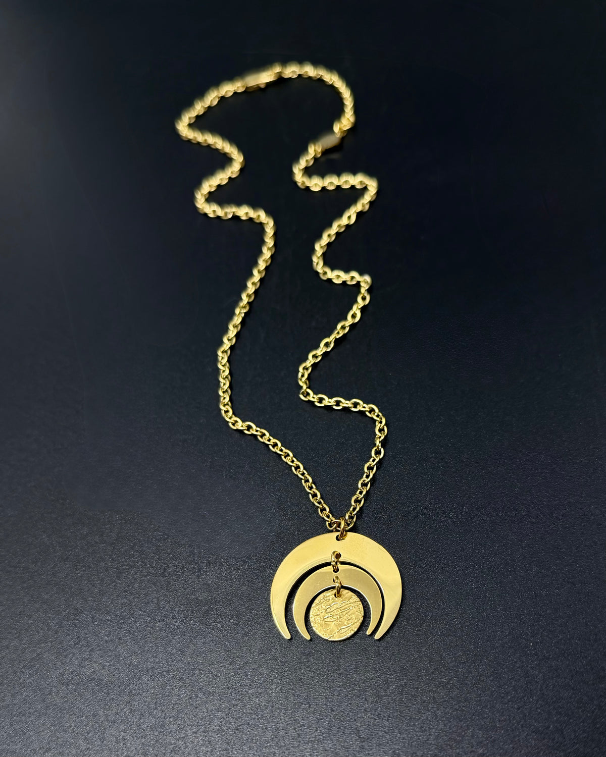 All gold Luna Phase necklace with 30mm sculptural crescent moon pendant and textured disc on stainless steel toggle chain, celestial statement jewellery