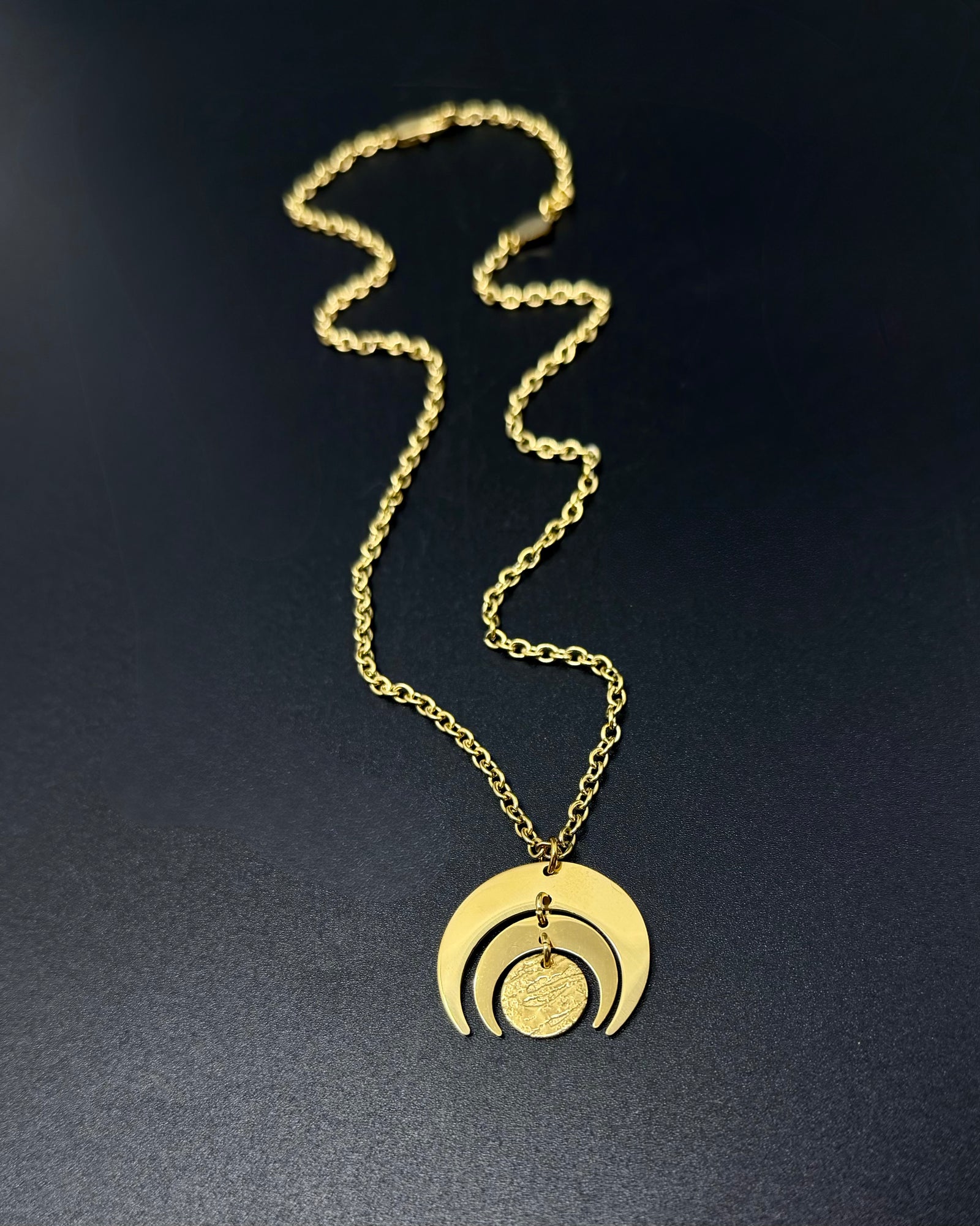 All gold Luna Phase necklace with 30mm sculptural crescent moon pendant and textured disc on stainless steel toggle chain, celestial statement jewellery