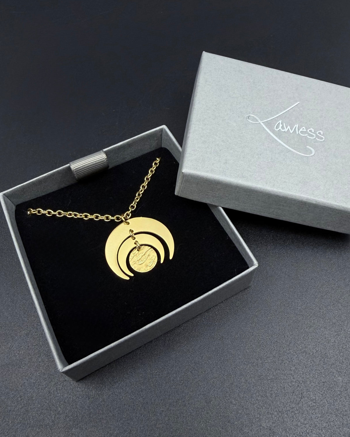 All gold Luna Phase necklace with 30mm sculptural crescent moon pendant and textured disc on stainless steel toggle chain, celestial statement jewellery