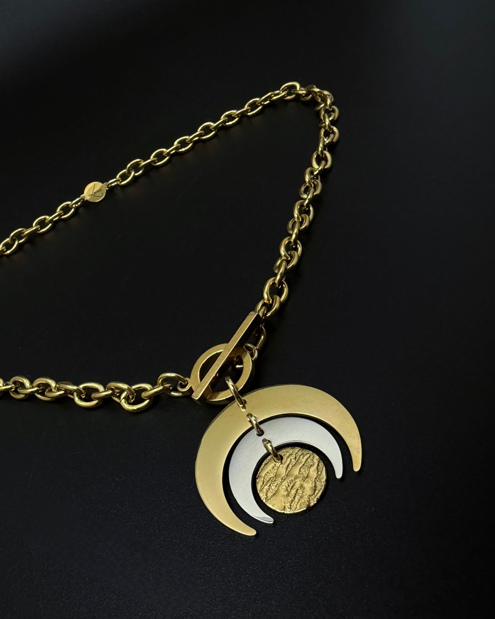 Gold and silver Luna Phase necklace with layered crescent moon pendant on chunky curb chain and toggle clasp, mixed-metal celestial jewellery by Lawless