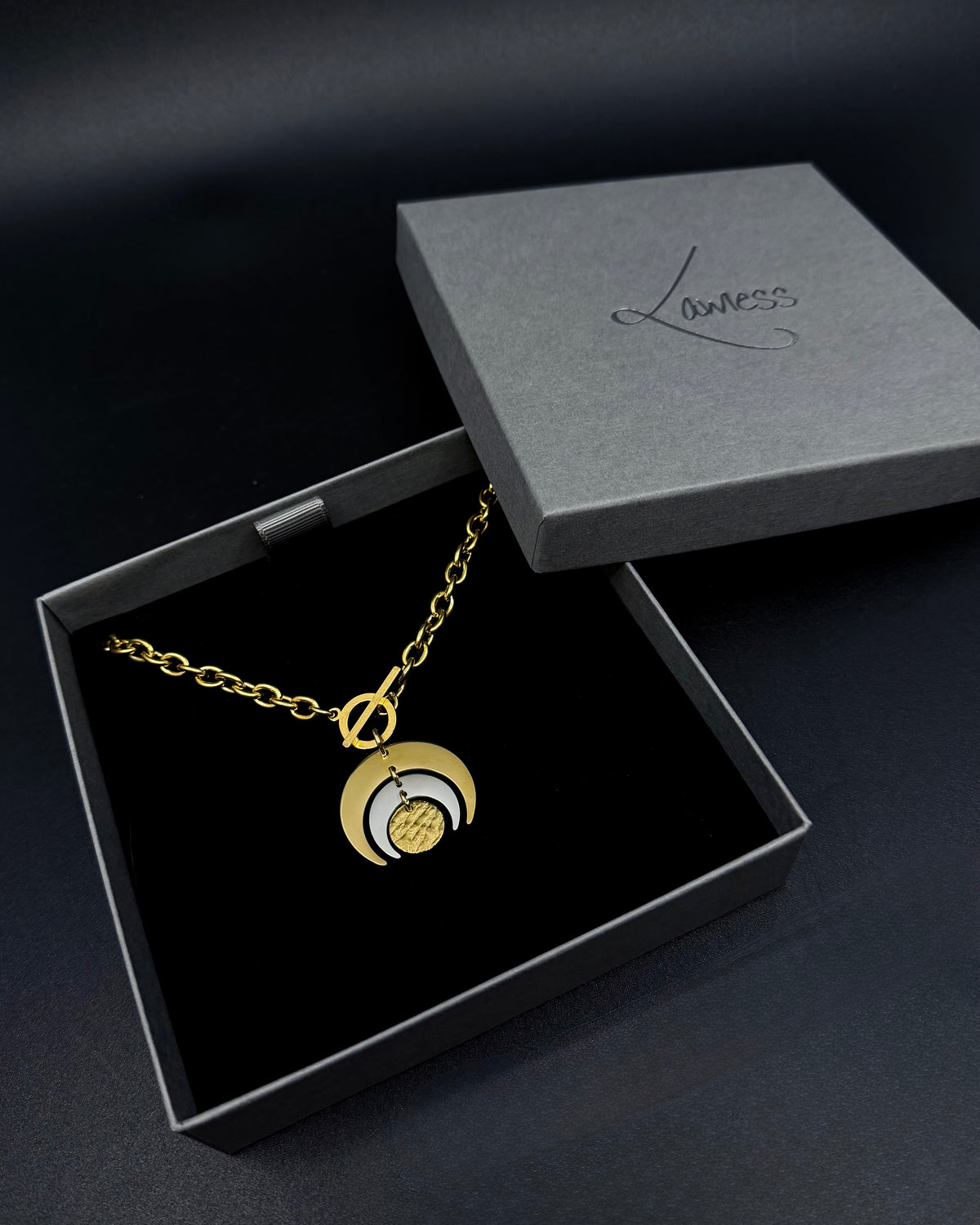 Gold and silver Luna Phase necklace with layered crescent moon pendant on chunky curb chain and toggle clasp, mixed-metal celestial jewellery by Lawless