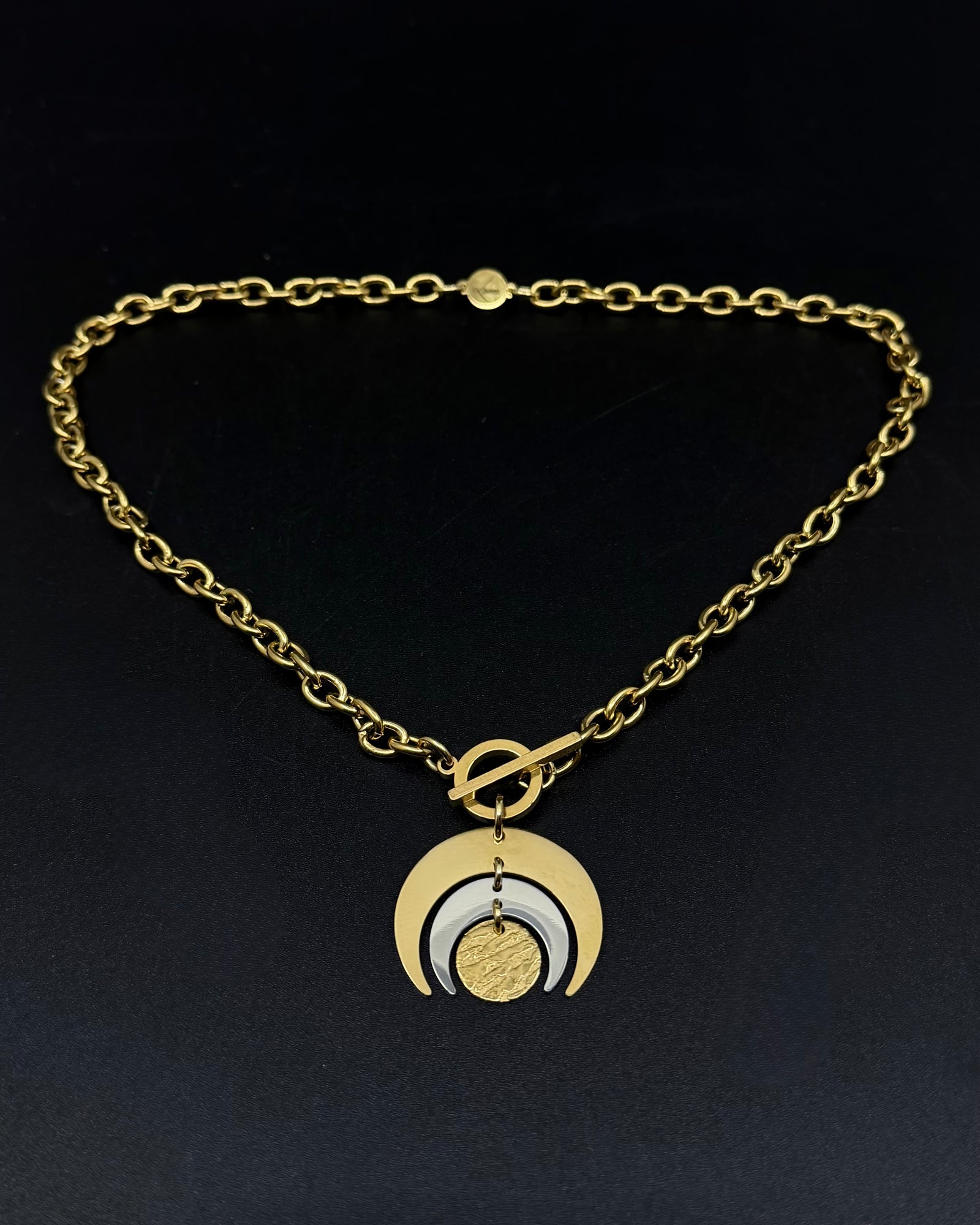 Gold and silver Luna Phase necklace with layered crescent moon pendant on chunky curb chain and toggle clasp, mixed-metal celestial jewellery by Lawless
