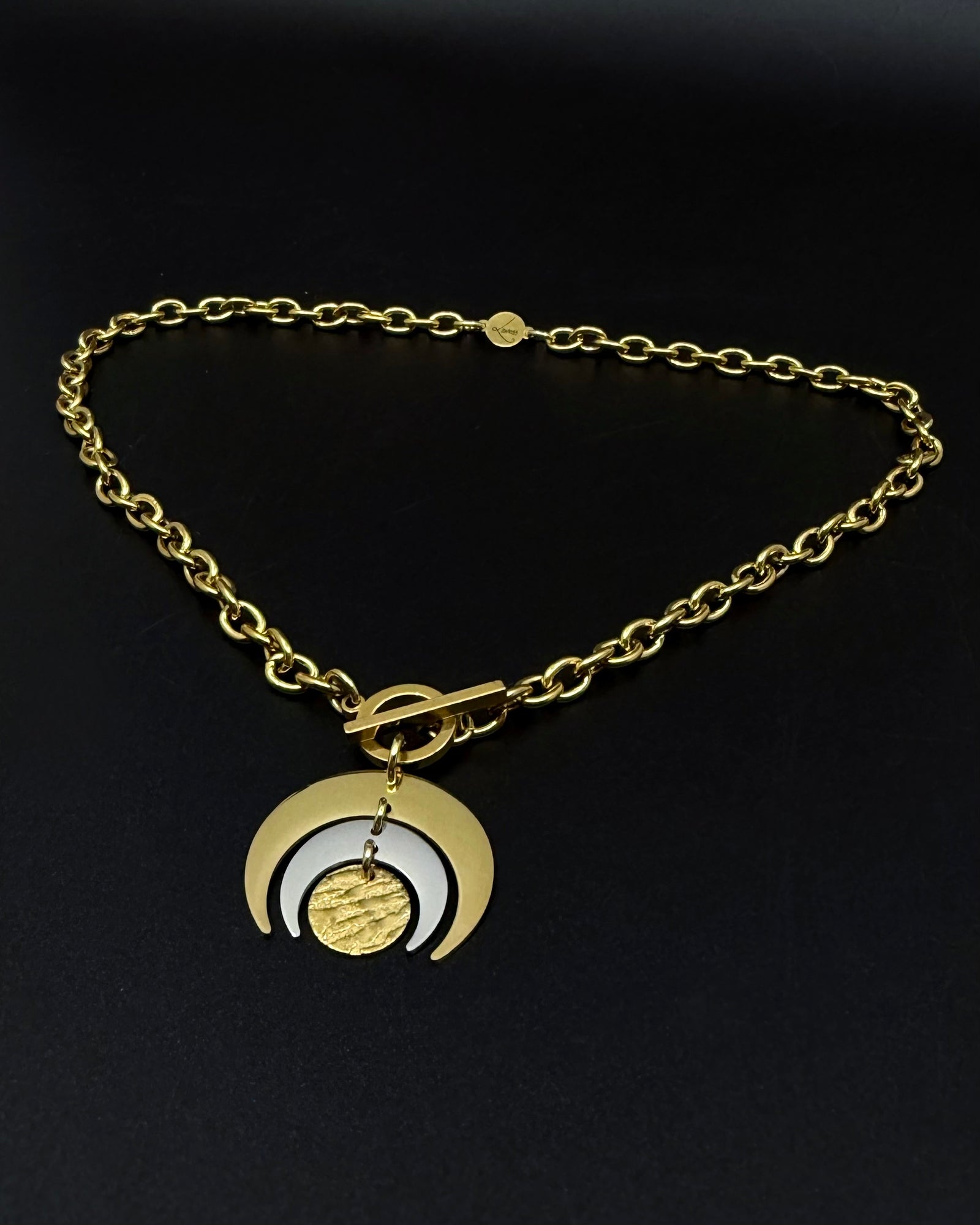 Gold and silver Luna Phase necklace with layered crescent moon pendant on chunky curb chain and toggle clasp, mixed-metal celestial jewellery by Lawless