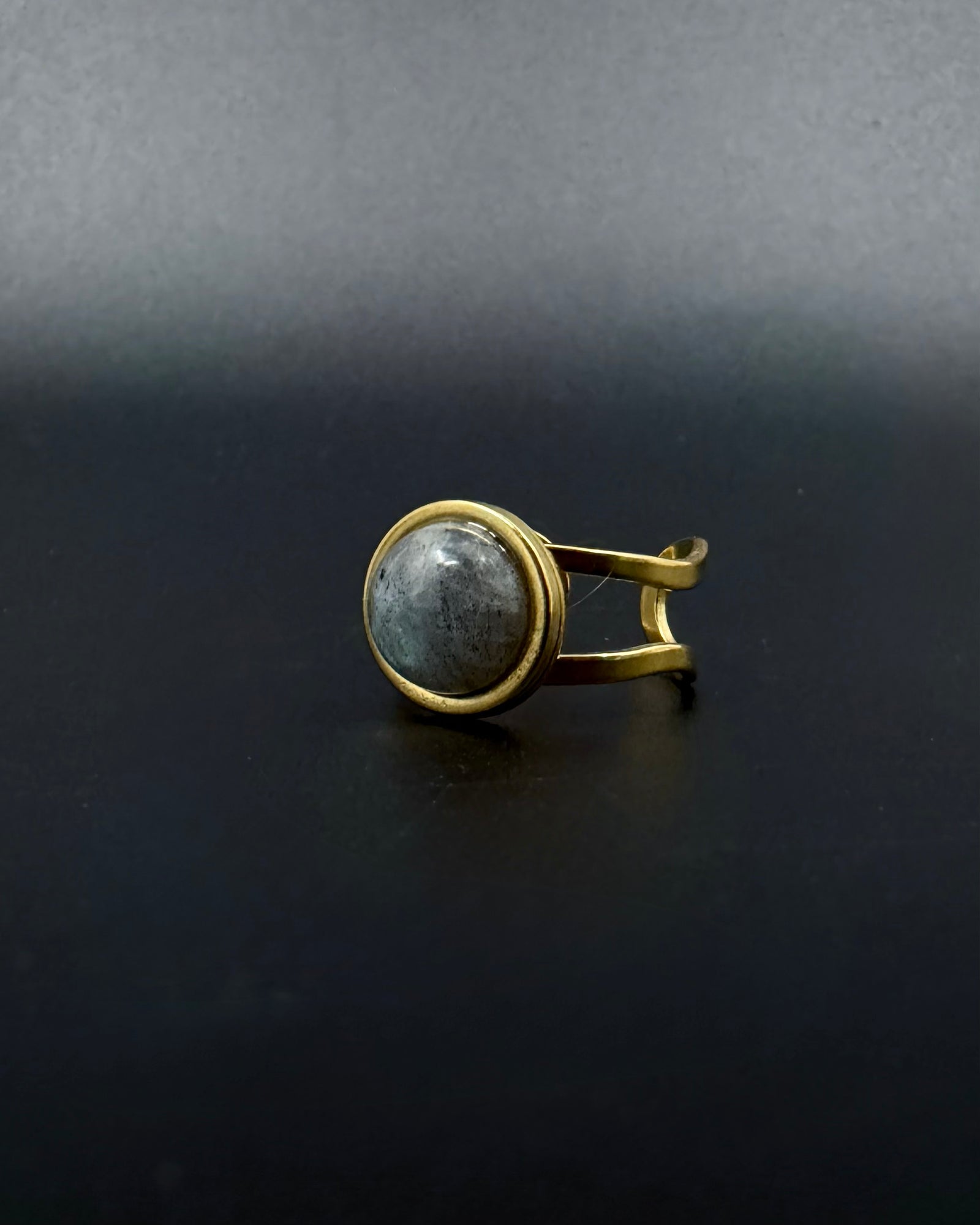 Gold adjustable statement ring with 10mm domed labradorite gemstone showing blue-grey iridescence, double-shank stainless steel band, Nebulae Core Ring by Lawless Jewellery