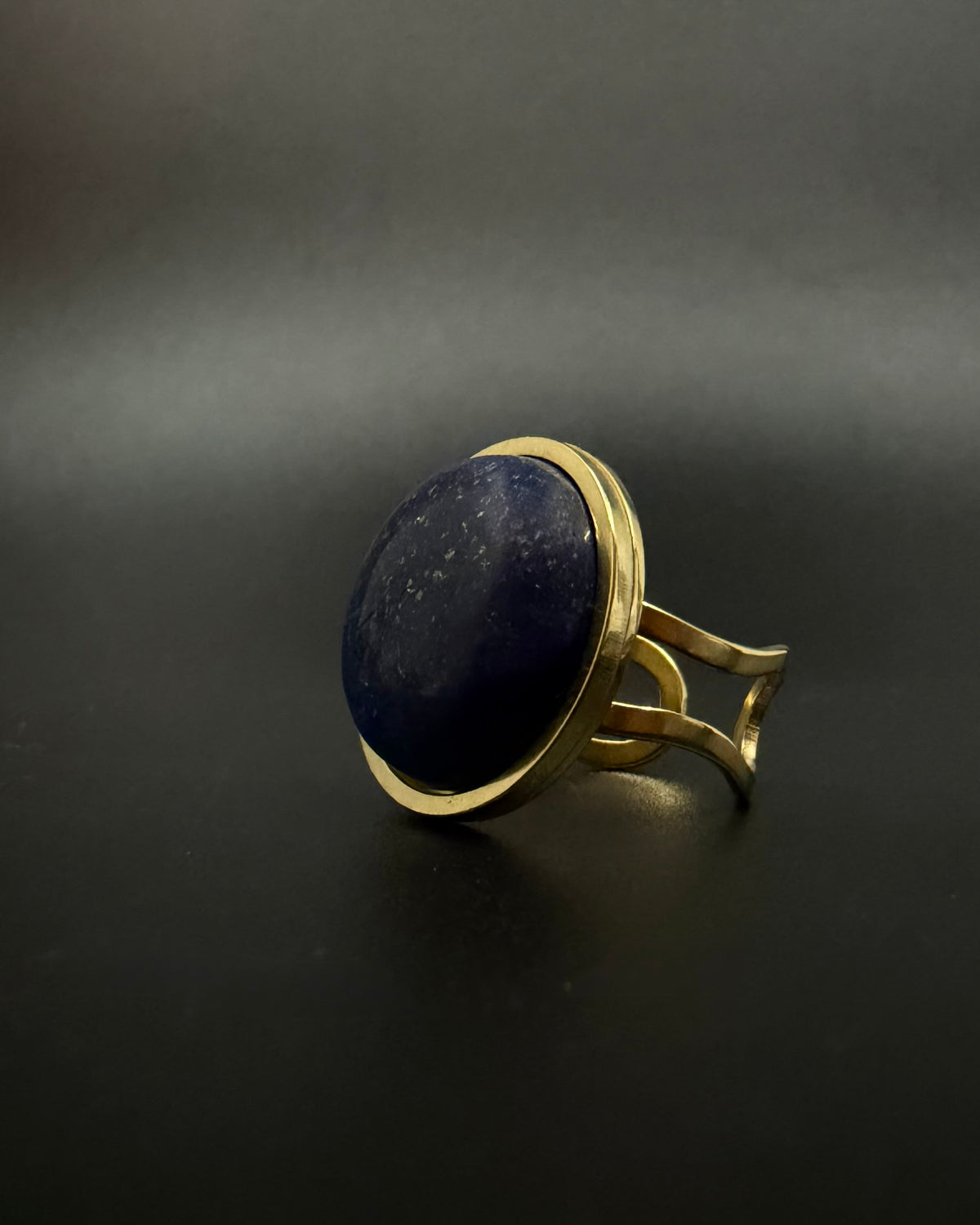 Nebulae Core adjustable ring in stainless steel featuring a 20mm lapis lazuli gemstone disc with deep blue and gold flecked detailing