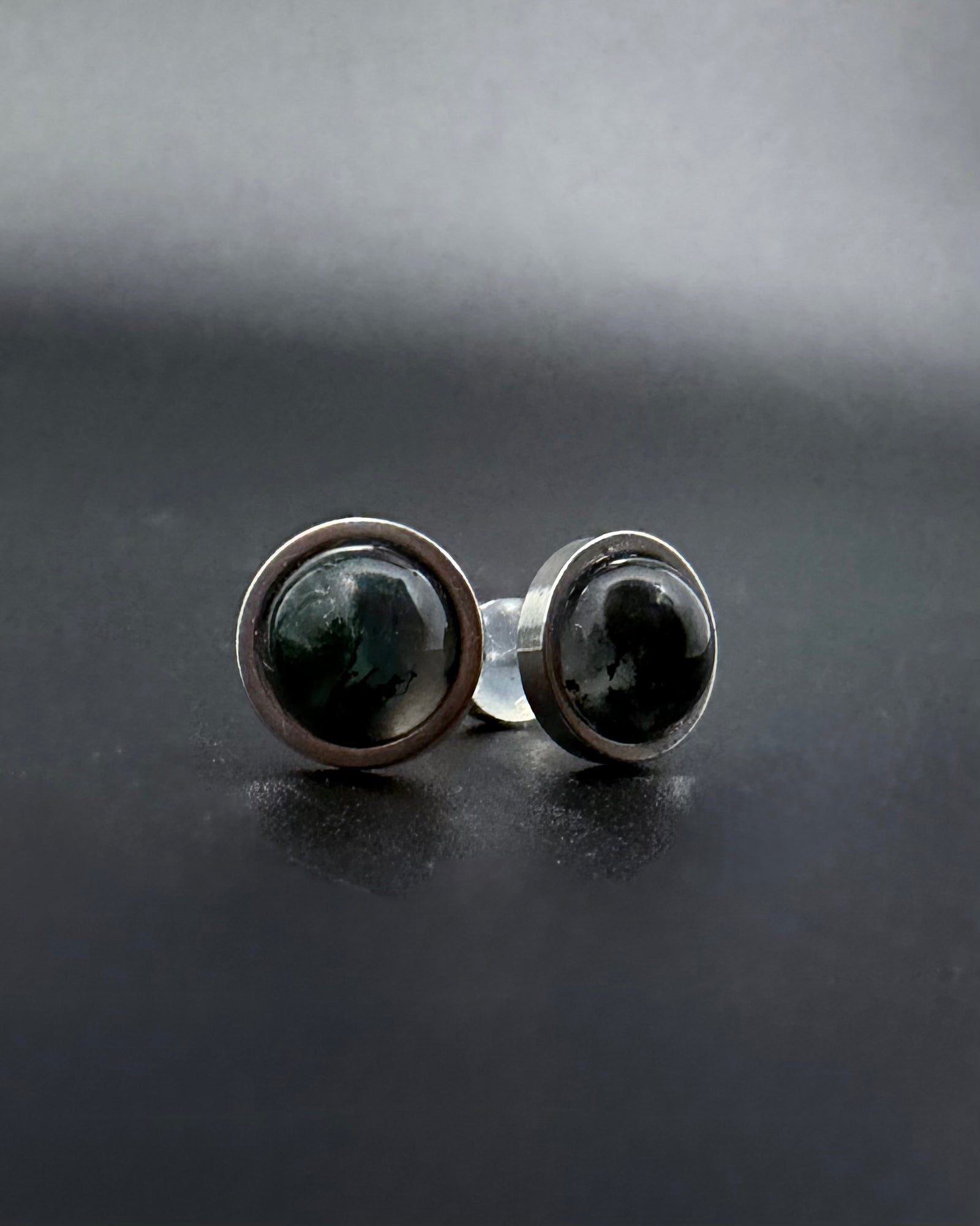 Silver stainless steel stud earrings with domed moss agate gemstones showing natural green inclusions, Nebulae Pulse Studs by Lawless Jewellery