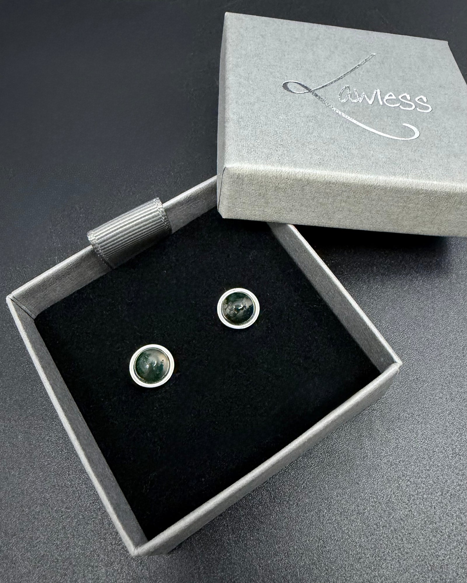 Silver stainless steel stud earrings with domed moss agate gemstones showing natural green inclusions, Nebulae Pulse Studs by Lawless Jewellery