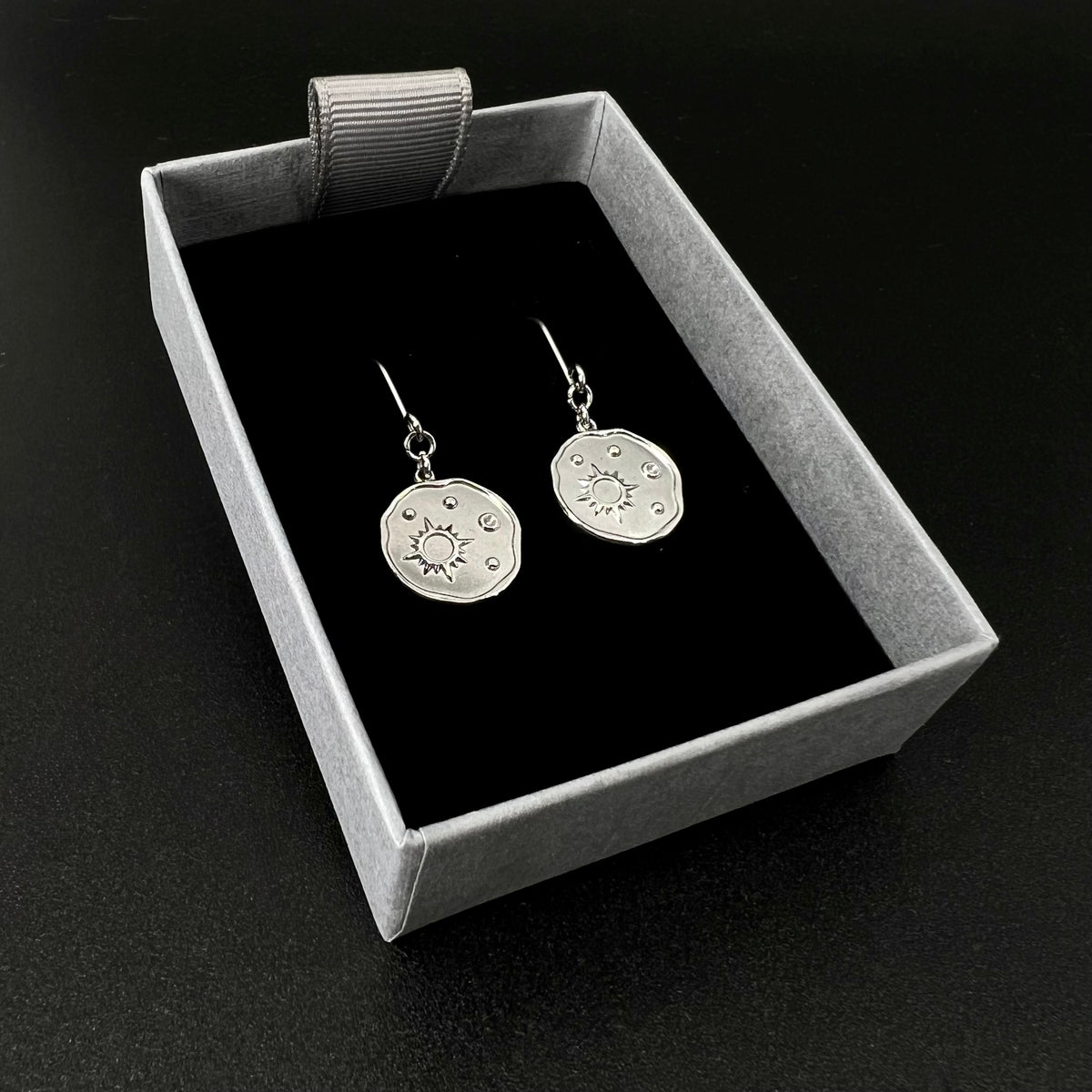 Silver stainless steel earrings with engraved star-motif discs, 1.5 cm wide with a 4 cm drop — Azimuth Earrings, Lawless Jewellery
