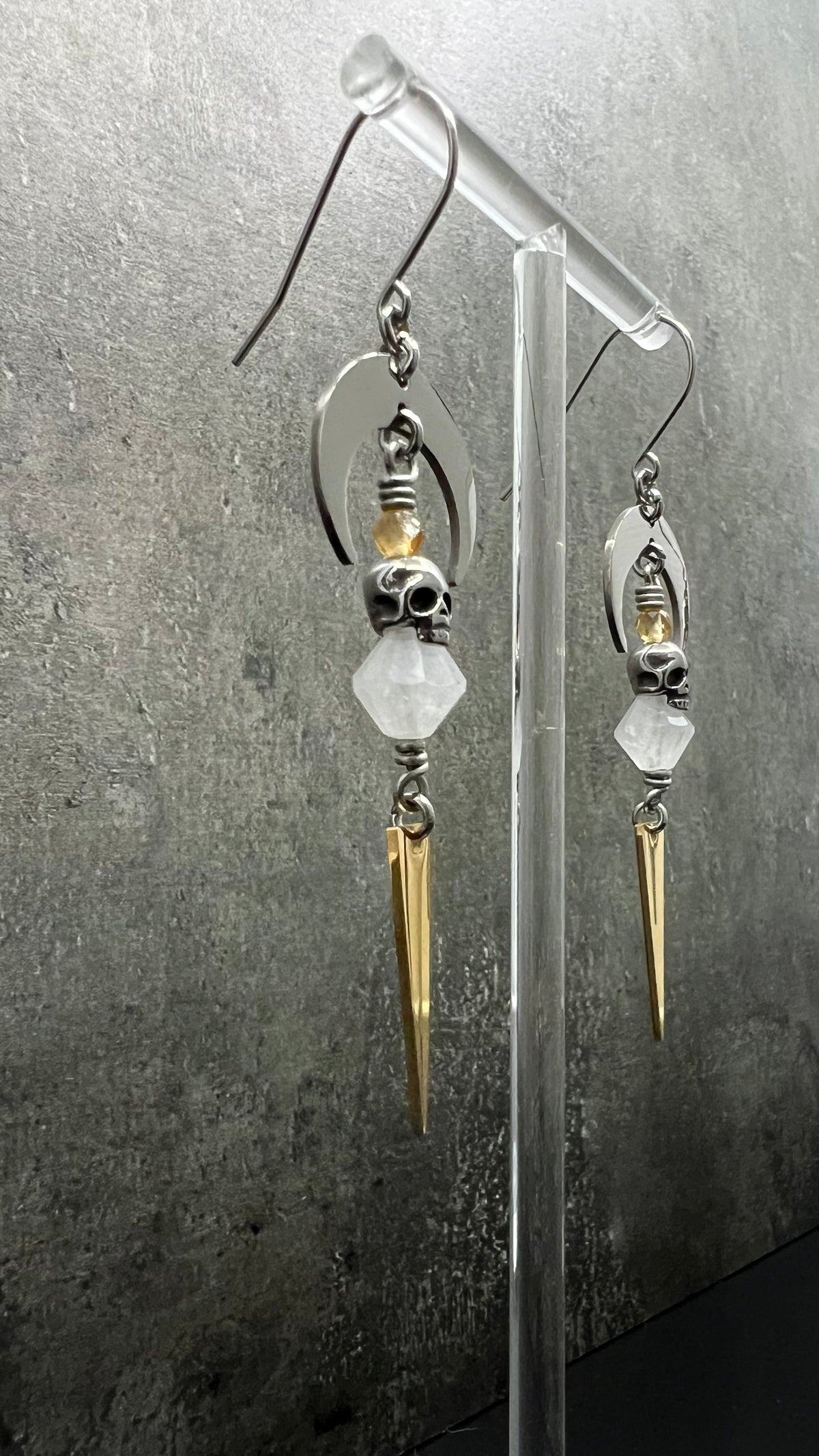 Silver and gold stainless steel arc earrings featuring Citrine and Quartz Crystal with 3D skull details, 8 cm length — Lawless Jewellery.
