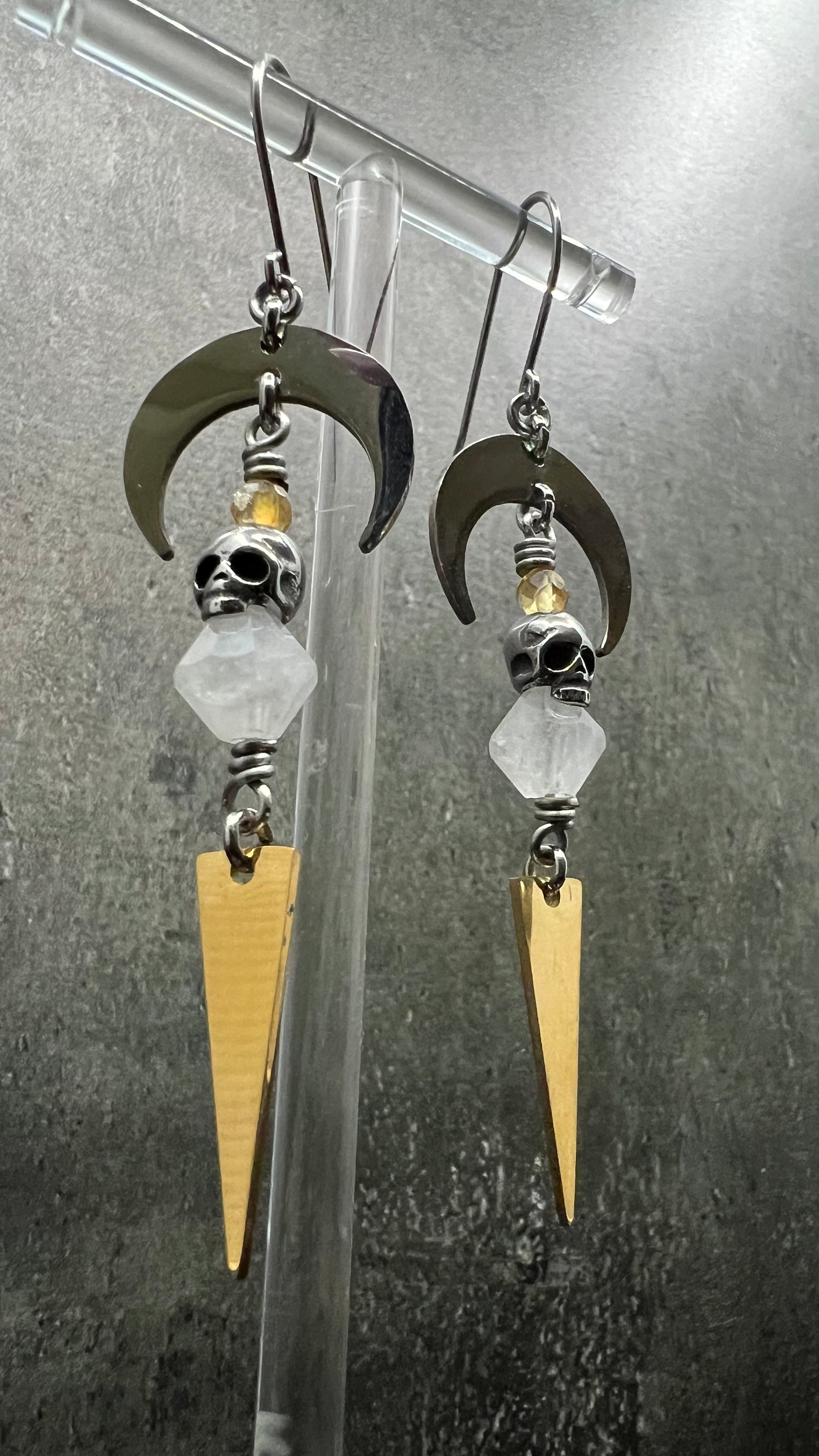 Silver and gold stainless steel arc earrings featuring Citrine and Quartz Crystal with 3D skull details, 8 cm length — Lawless Jewellery.