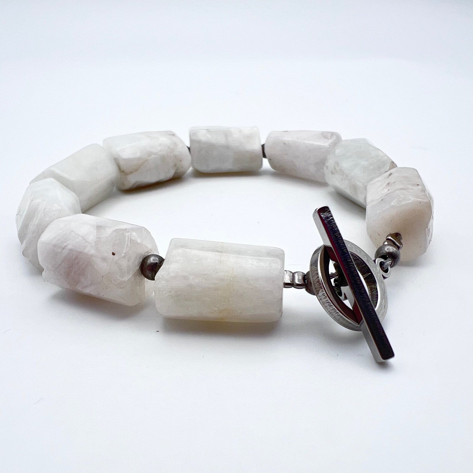 Stainless steel cuff bracelet featuring raw barrel-cut Moonstone gemstones, approximately 1.5 × 1 cm each, designed for wrists up to 17 cm — Lawless Jewellery.