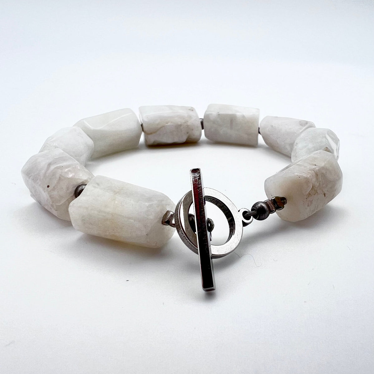 Stainless steel cuff bracelet featuring raw barrel-cut Moonstone gemstones, approximately 1.5 × 1 cm each, designed for wrists up to 17 cm — Lawless Jewellery.