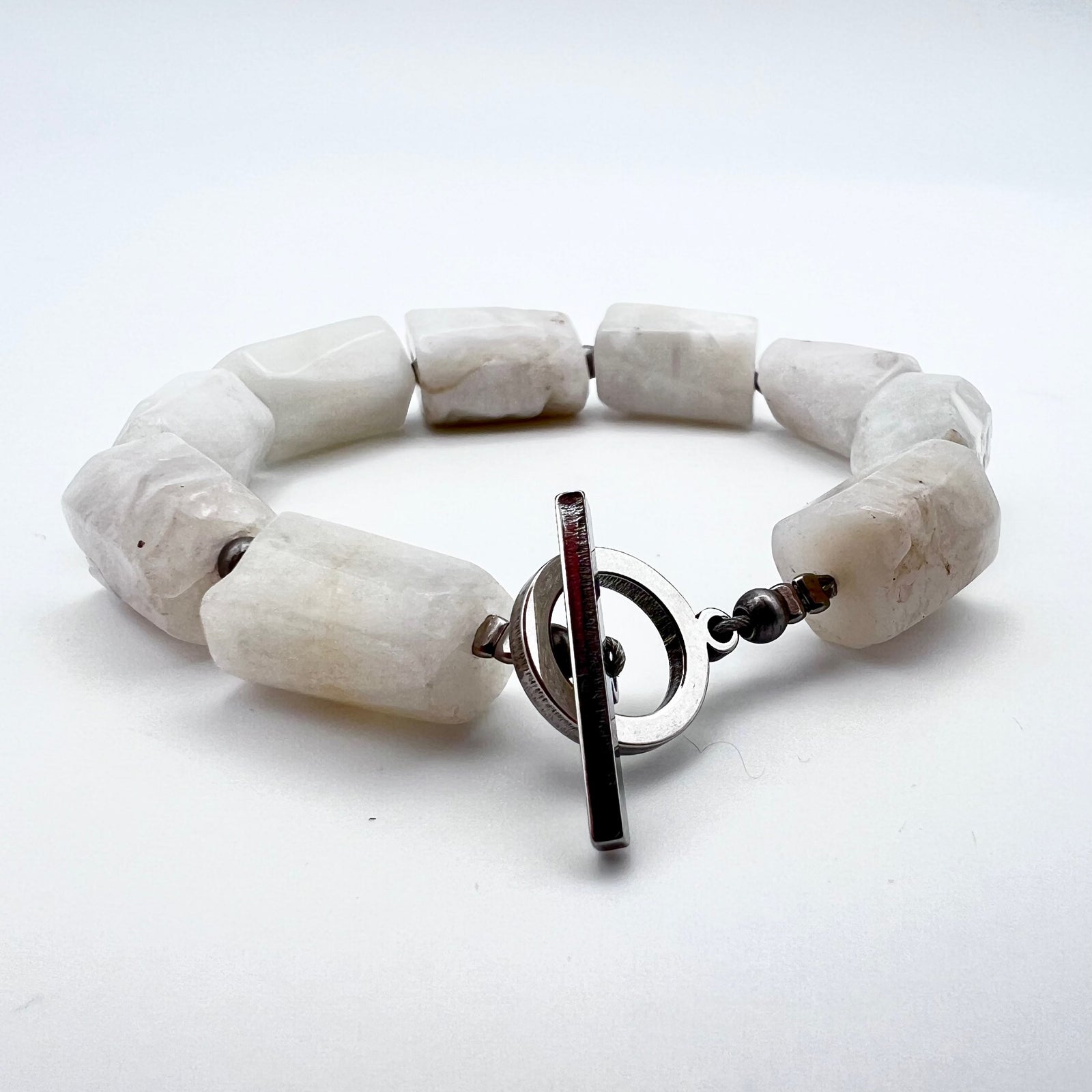 Stainless steel cuff bracelet featuring raw barrel-cut Moonstone gemstones, approximately 1.5 × 1 cm each, designed for wrists up to 17 cm — Lawless Jewellery.