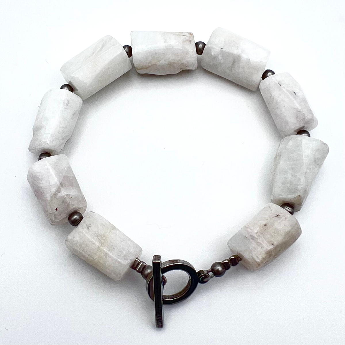 Stainless steel cuff bracelet featuring raw barrel-cut Moonstone gemstones, approximately 1.5 × 1 cm each, designed for wrists up to 17 cm — Lawless Jewellery.