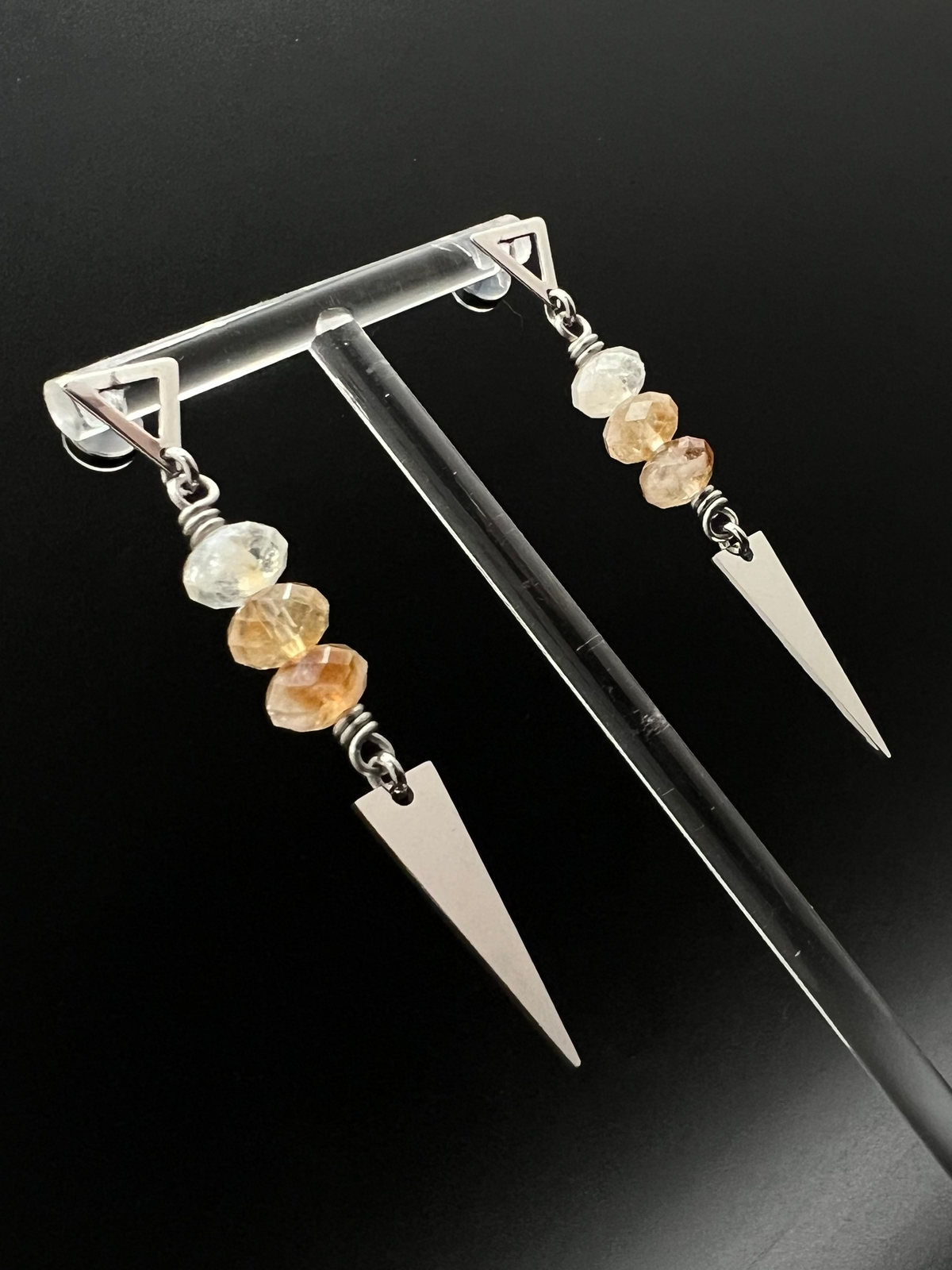 Stainless steel spear-drop earrings with triangle studs and three faceted citrine gemstones, inspired by Orion’s celestial geometry — Lawless Jewellery.