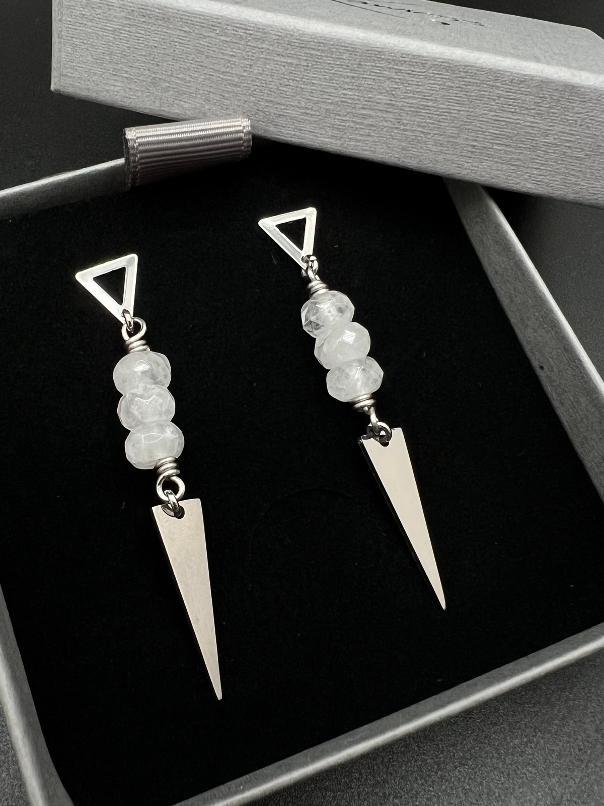 Stainless steel spear-drop earrings with triangle studs and three faceted clear quartz beads, 6.5 cm length, inspired by Orion’s celestial geometry — Lawless Jewellery.