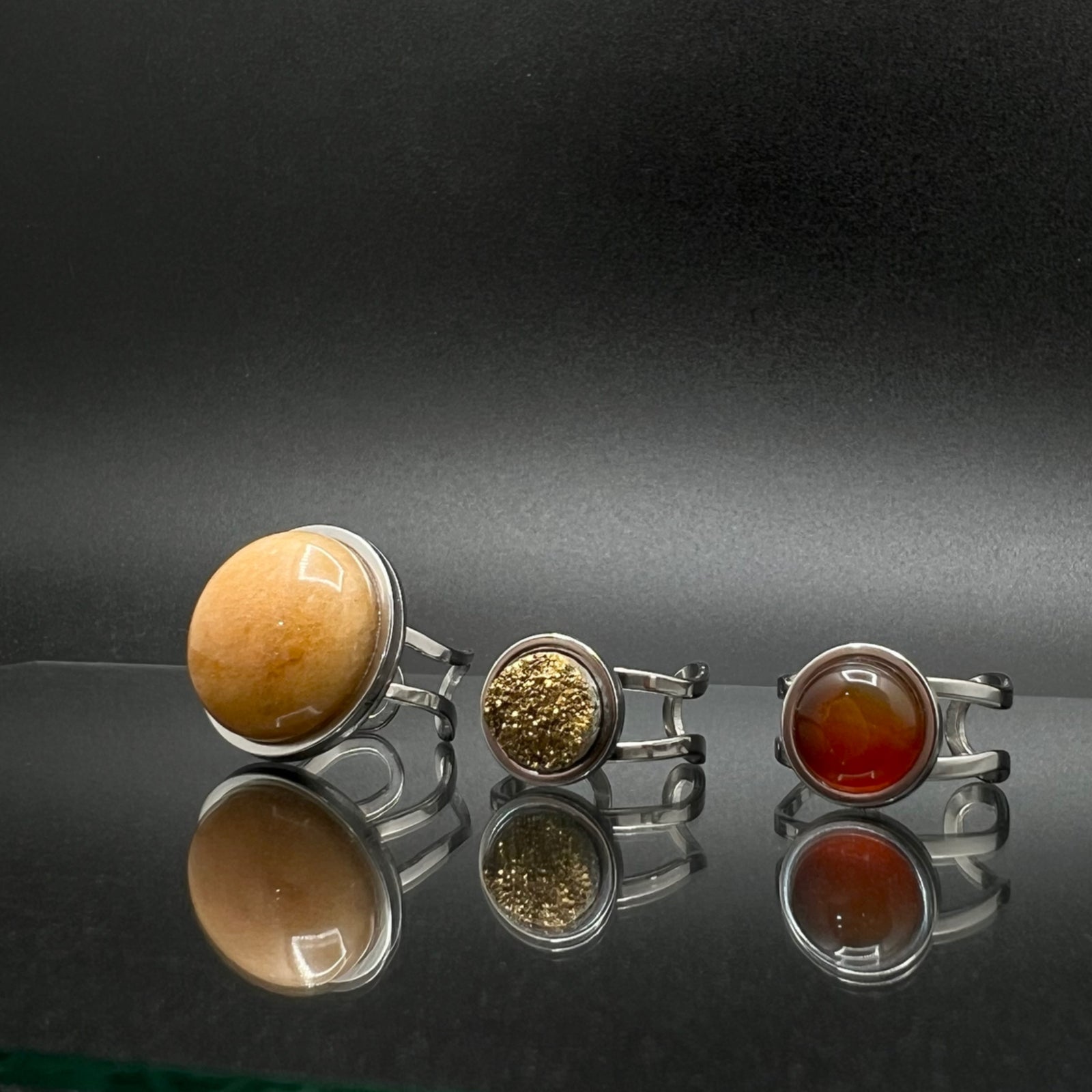 Set of three stainless steel adjustable rings featuring a 20 mm Yellow Aventurine cabochon, 10 mm Gold Druzy cabochon, and 10 mm Carnelian cabochon — Lawless Jewellery.