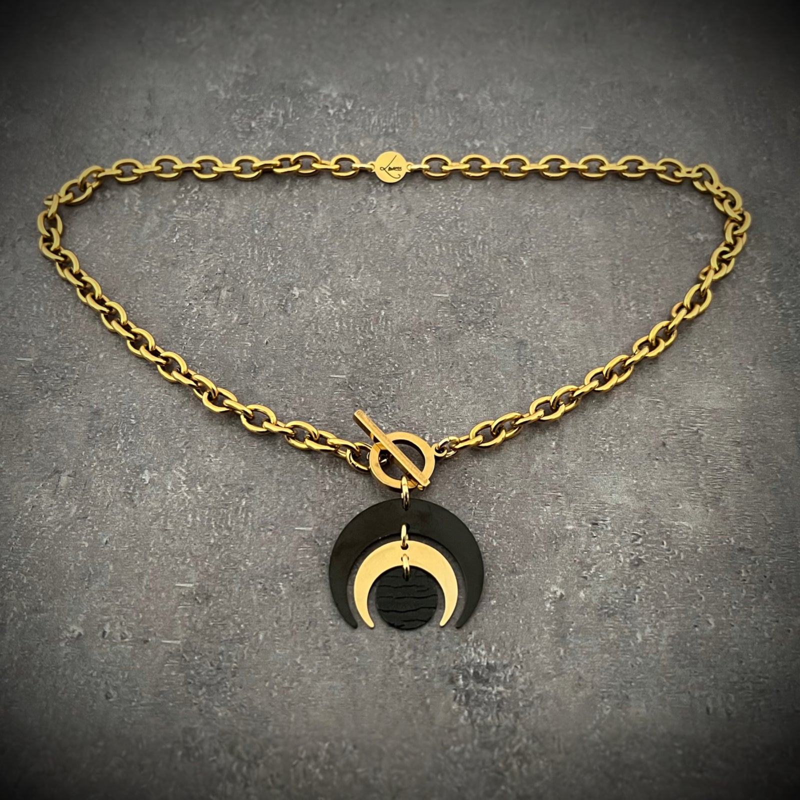 Gold and black stainless steel Luna Phase Necklace with sculptural crescent pendant and chunky curb chain, toggle fastening — Lawless Jewellery