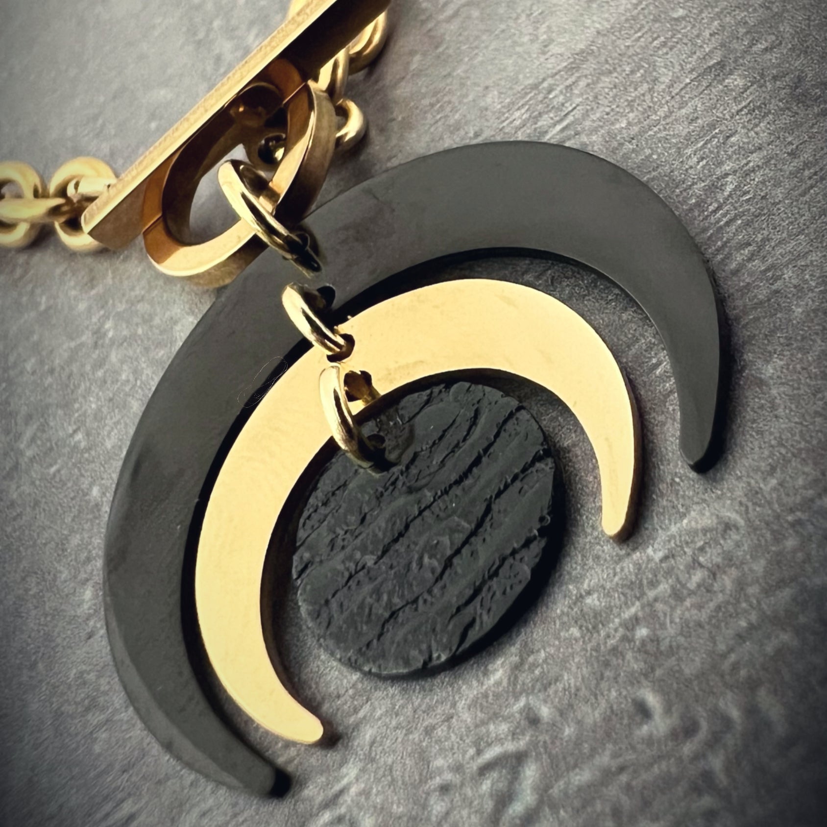 Gold and black stainless steel Luna Phase Necklace with sculptural crescent pendant and chunky curb chain, toggle fastening — Lawless Jewellery