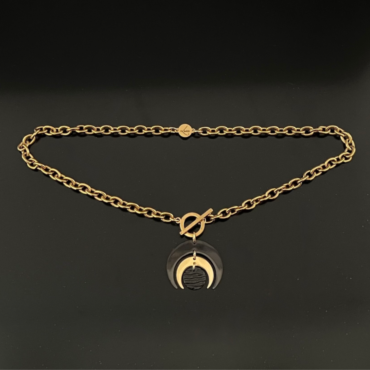 Gold and black stainless steel Luna Phase Necklace with sculptural crescent pendant and chunky curb chain, toggle fastening — Lawless Jewellery