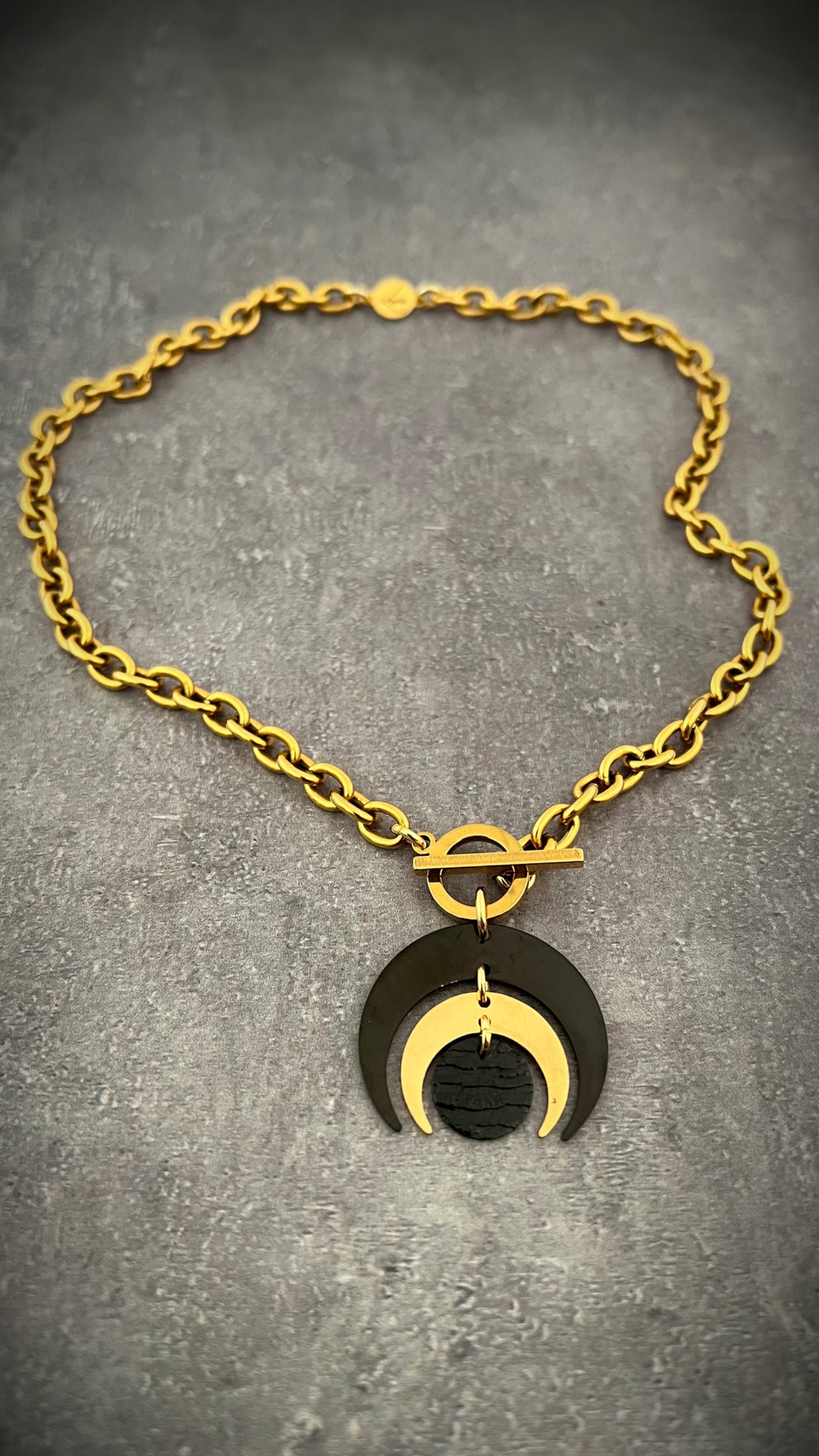 Gold and black stainless steel Luna Phase Necklace with sculptural crescent pendant and chunky curb chain, toggle fastening — Lawless Jewellery