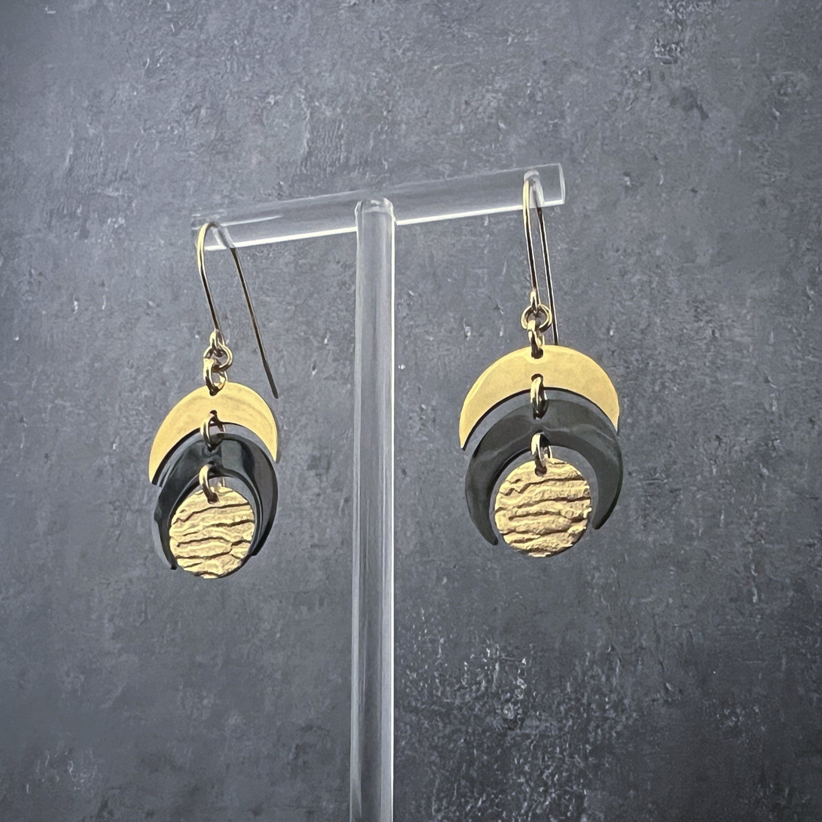 Gold and black stainless steel earrings with crescent and textured disc design inspired by lunar phases, lightweight and hypoallergenic — Lawless Jewellery.